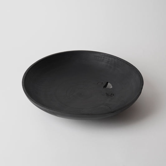 Black wooden plate on a white background