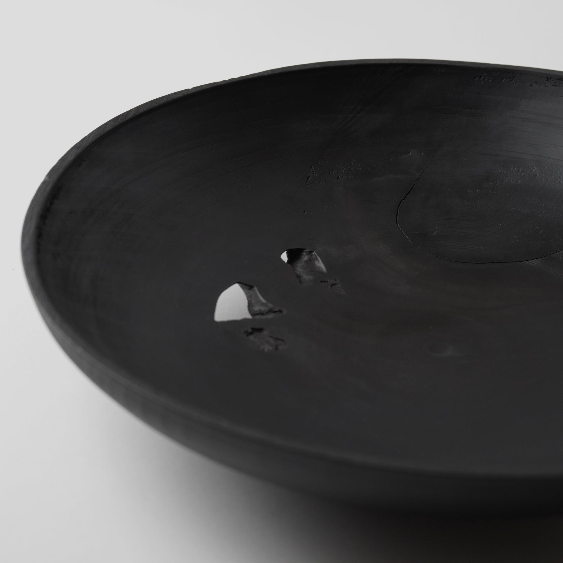 Black wooden bowl on a light gray background