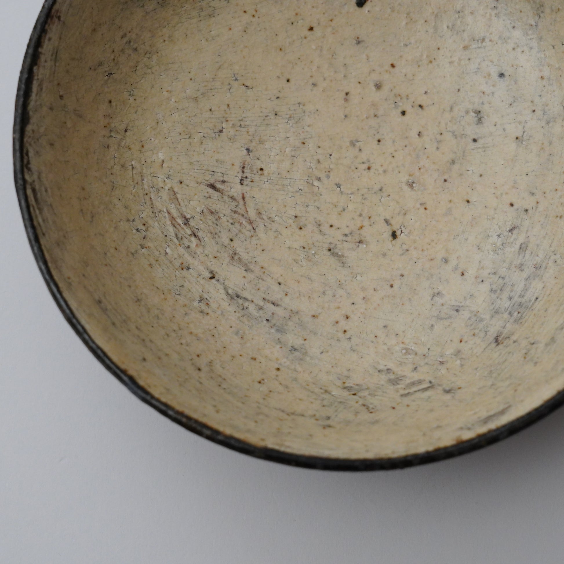 Close-up of a ceramic bowl's interior with a textured surface.