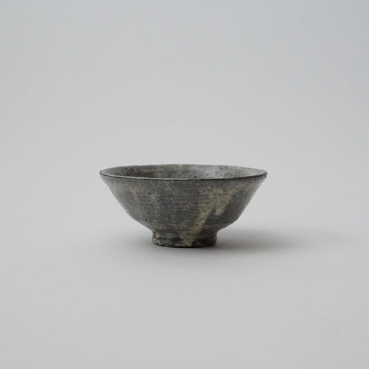A black ceramic bowl with a simple design, displayed against a neutral background.