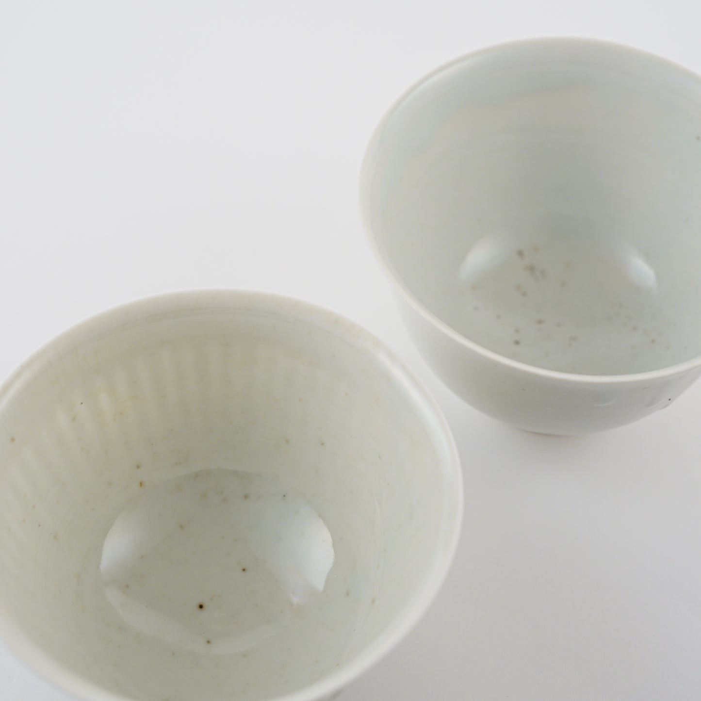 Two white ceramic bowls on a light gray background