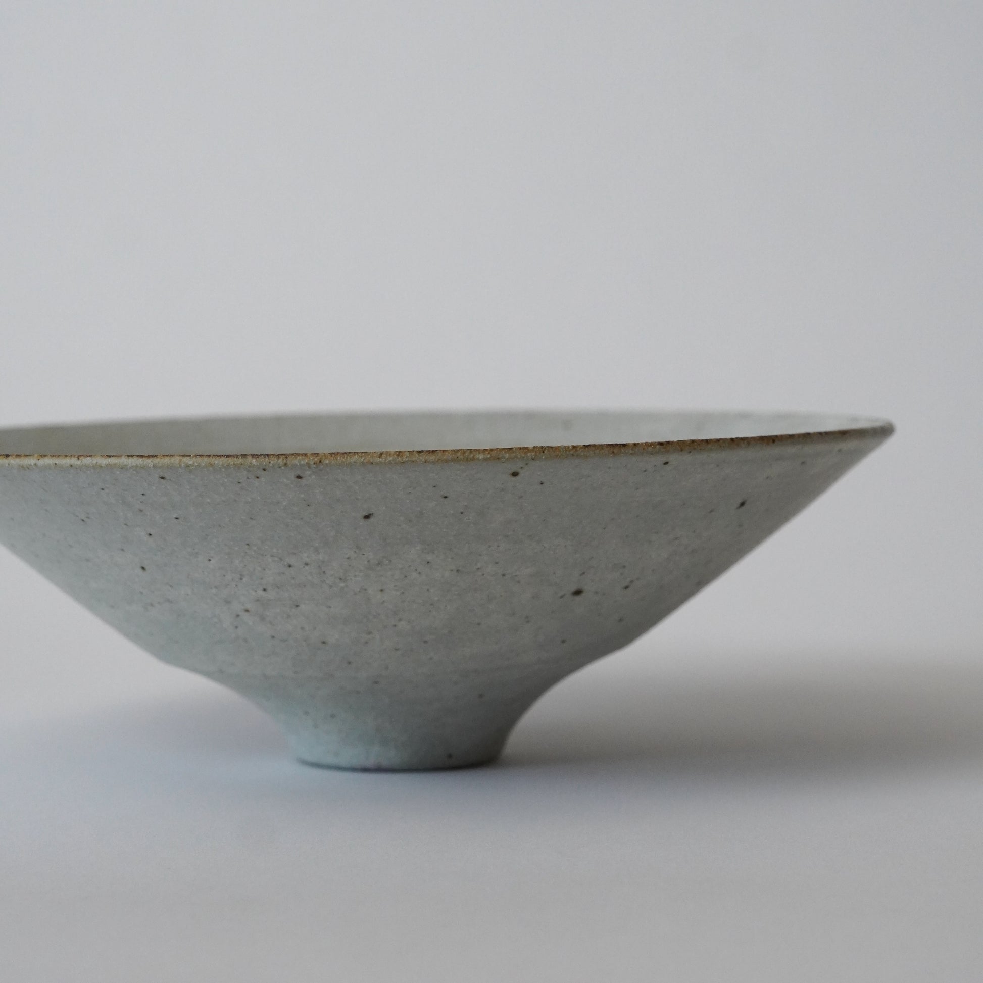 Ceramic bowl with a textured surface on a plain background