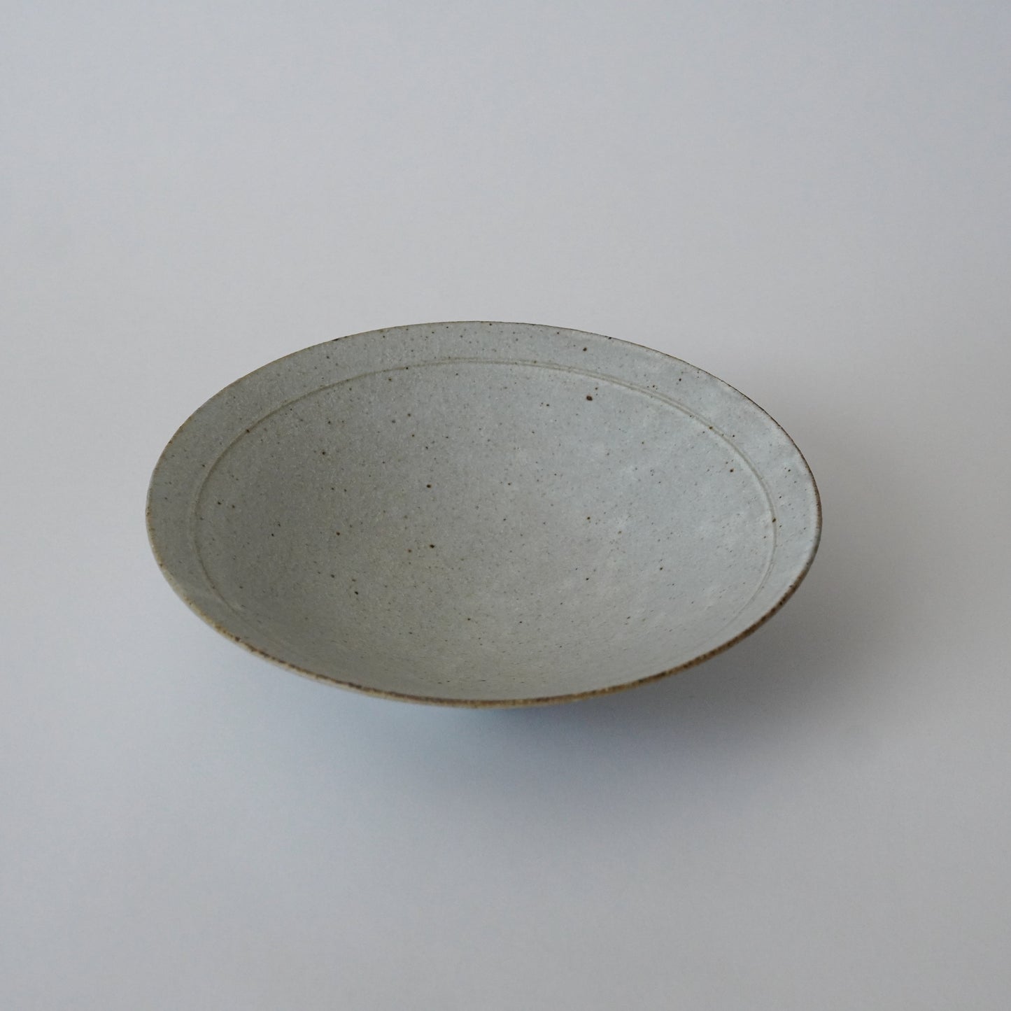 Gray ceramic plate on a white background