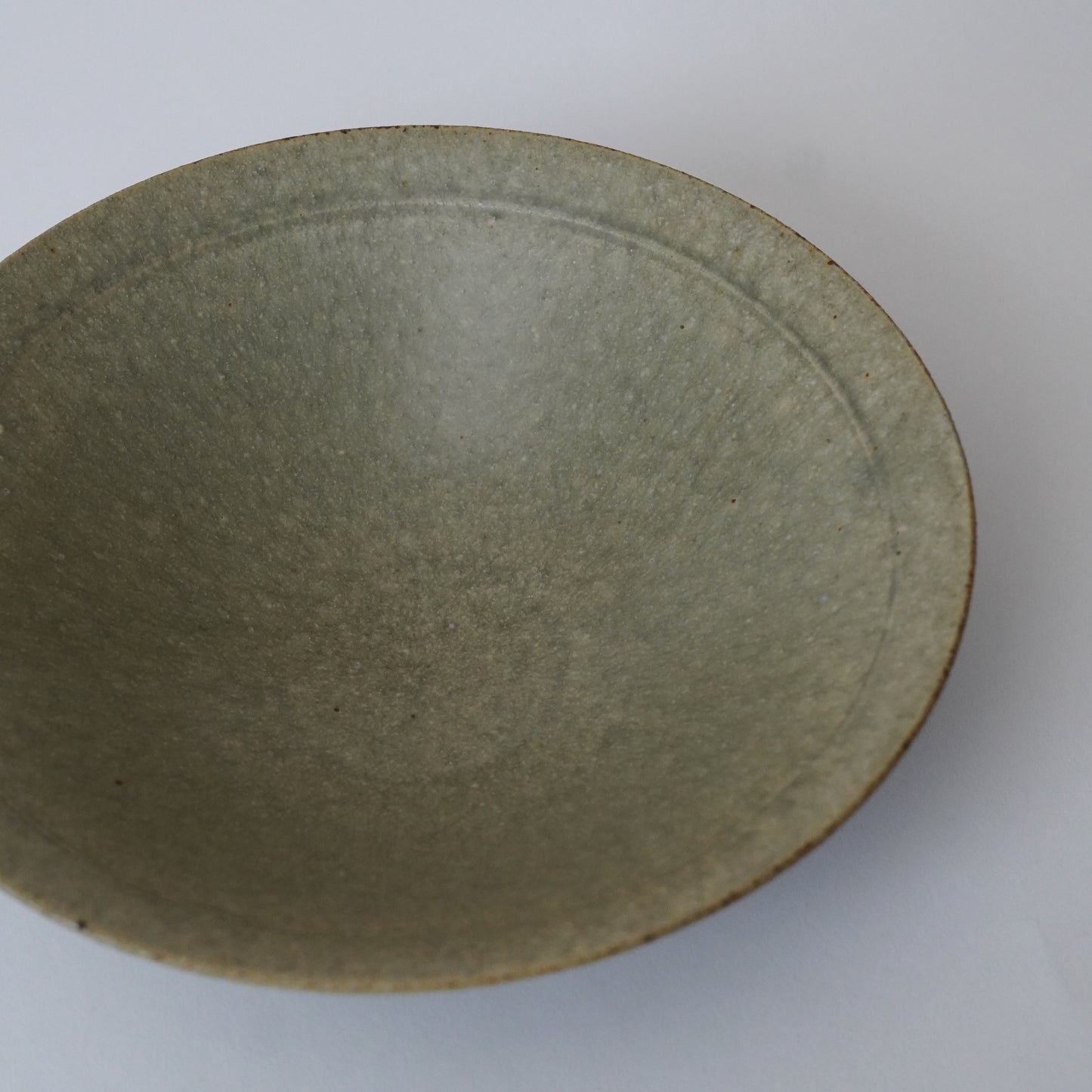 Green ceramic bowl on a white background