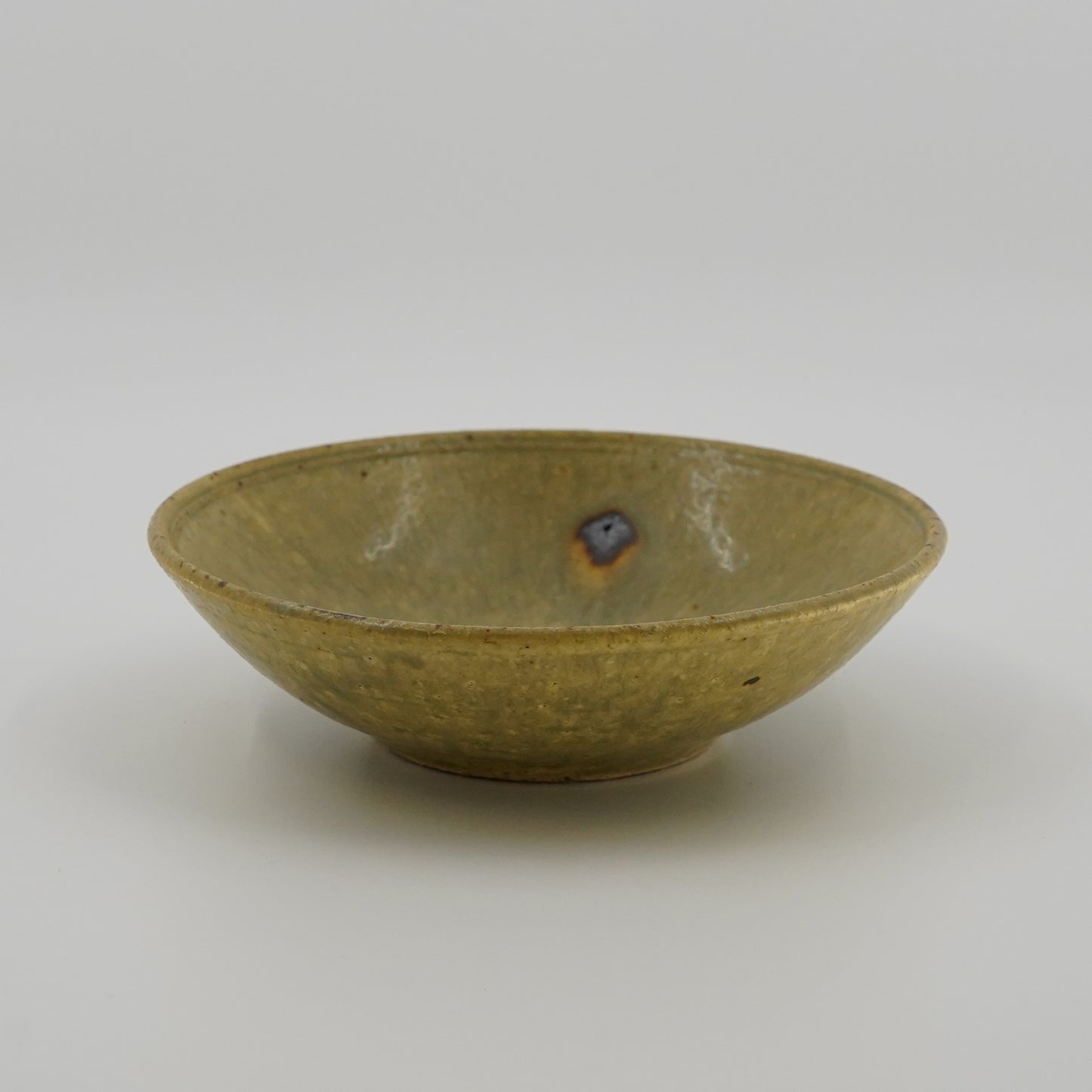 Green ceramic bowl on a white background
