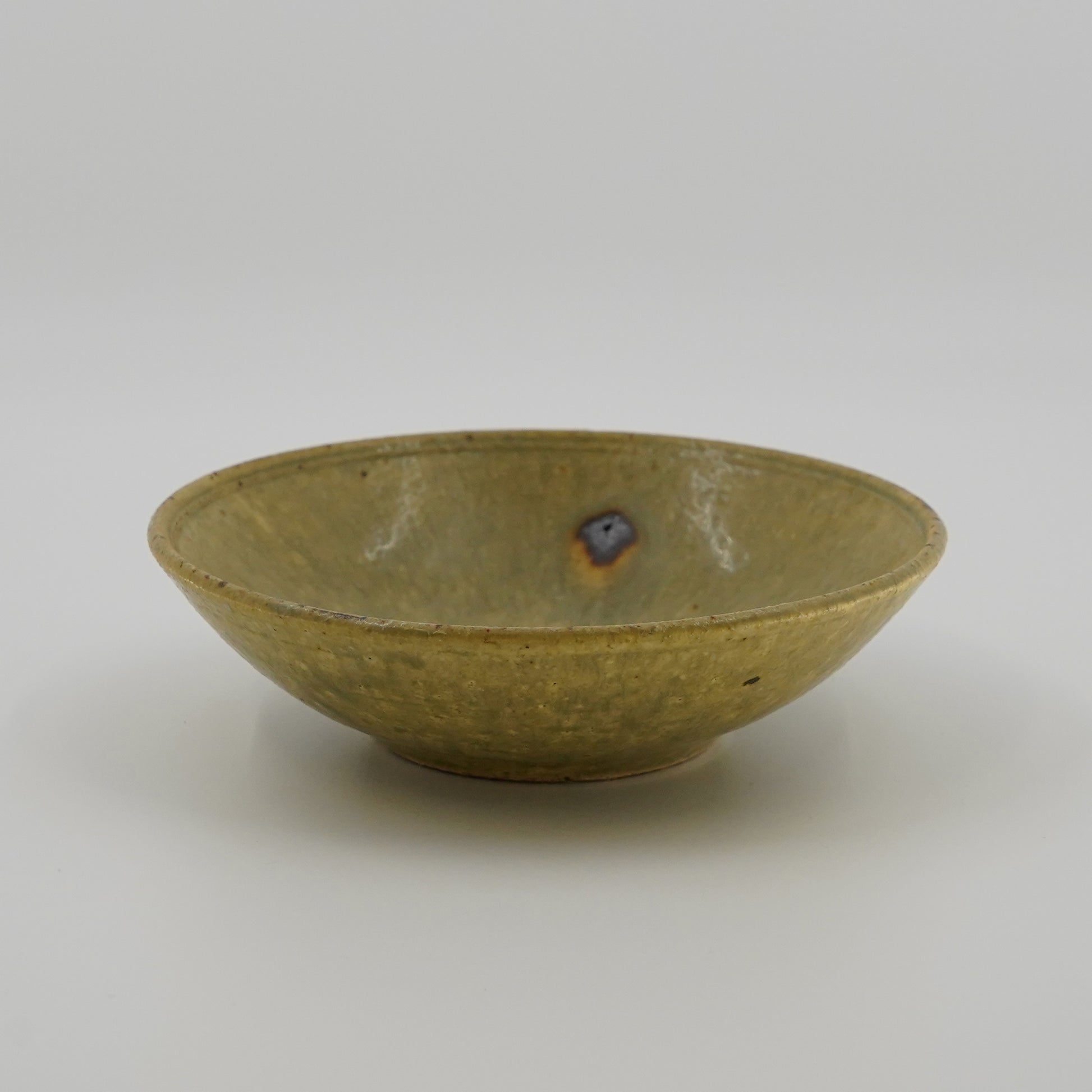Green ceramic bowl on a white background