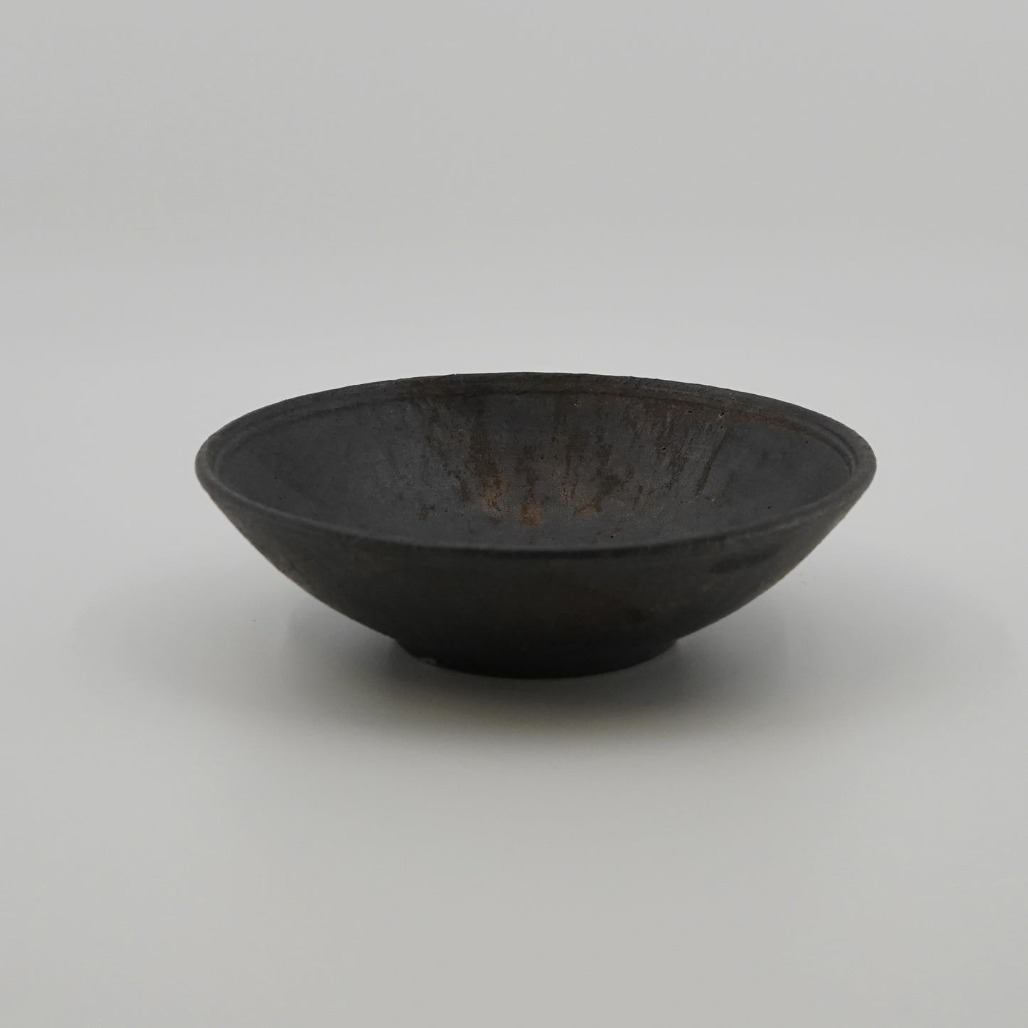 Black ceramic bowl on a white background