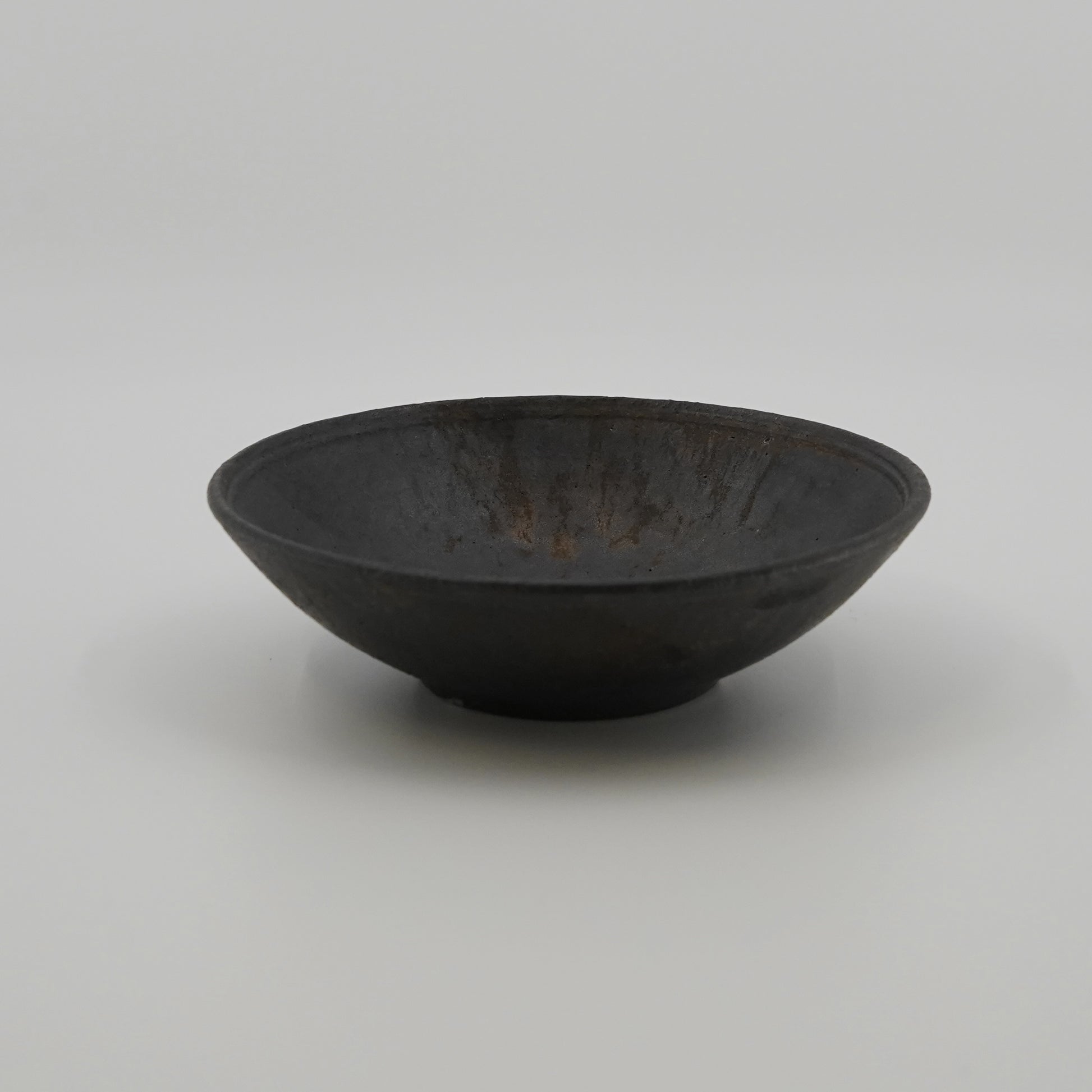 Black ceramic bowl on a white background