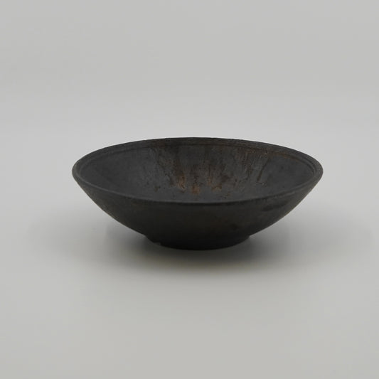 Black ceramic bowl on a white background