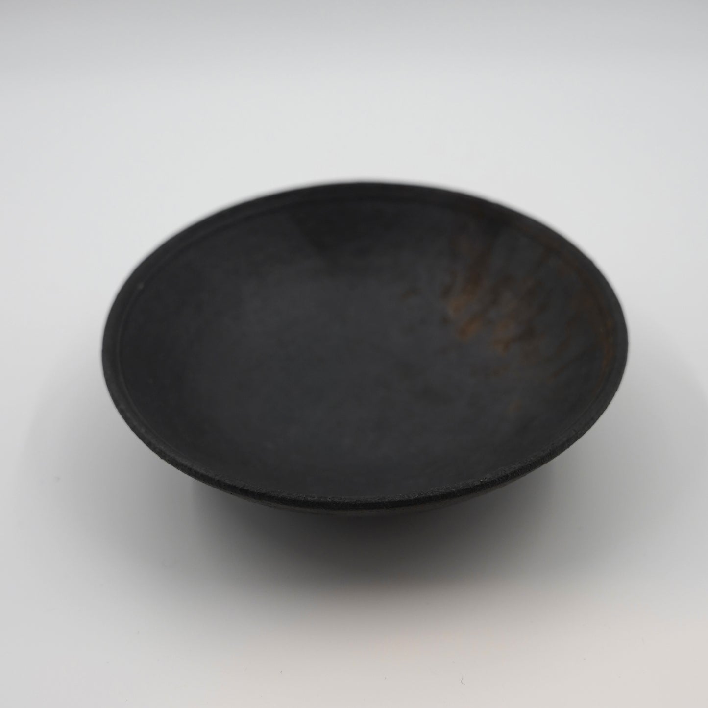 Black ceramic bowl on a white background