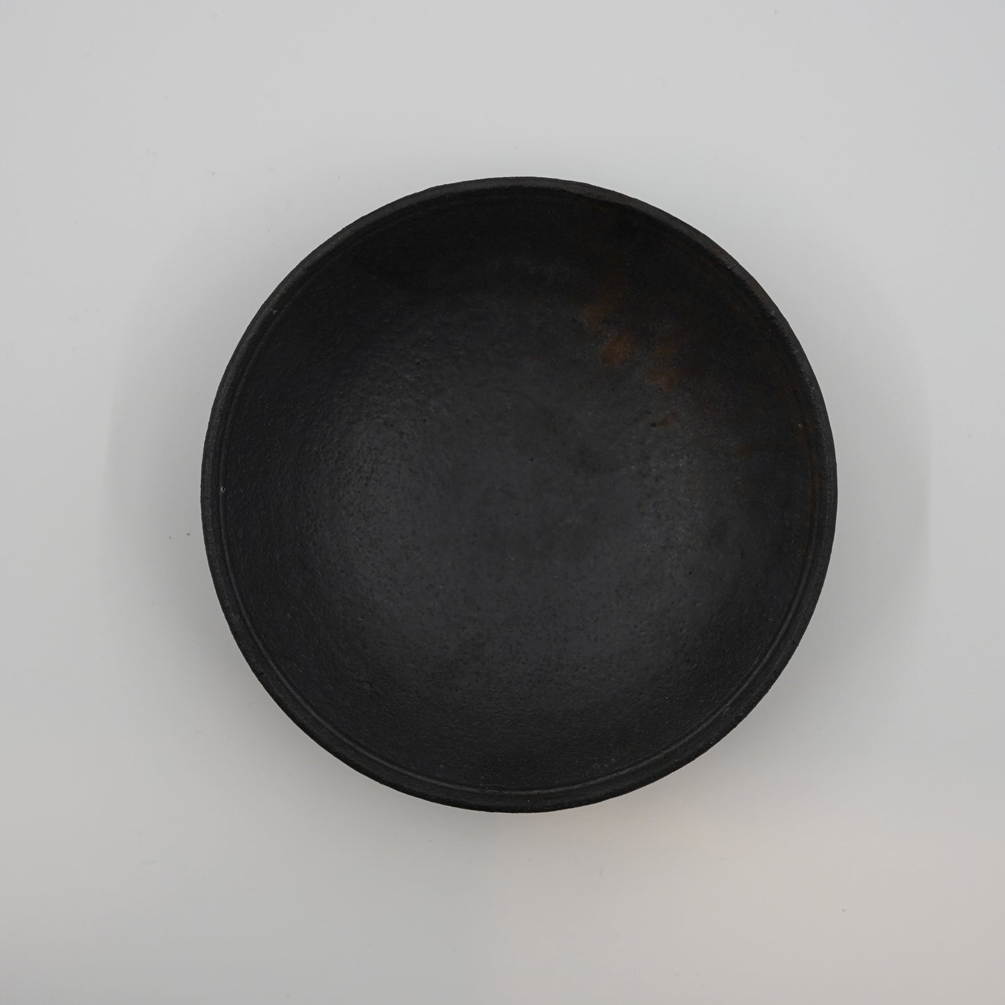Black ceramic plate on a light gray background