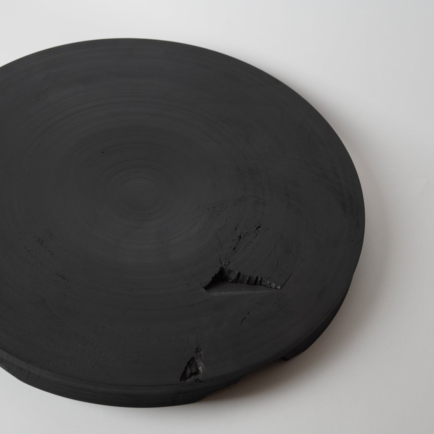 Round black stone on a white background