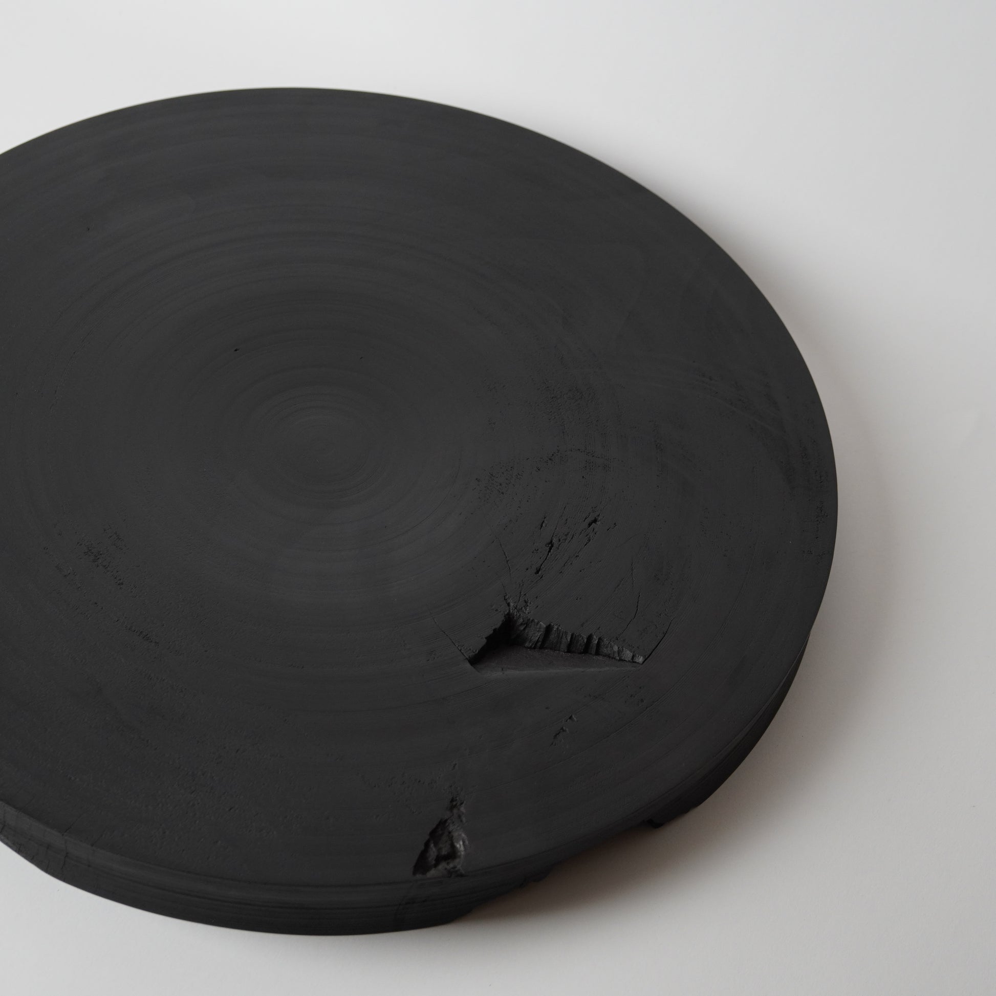 Round black stone on a white background