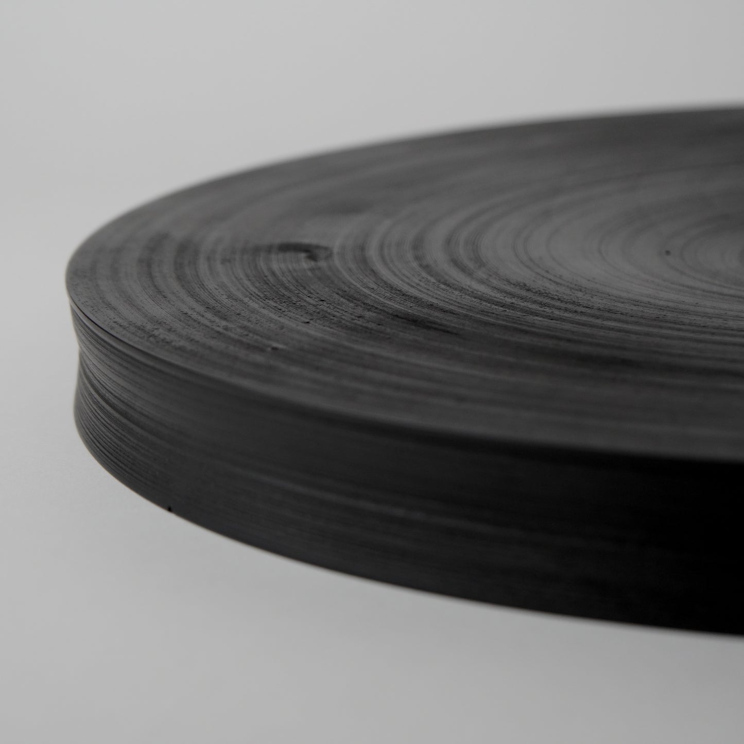 Roll of black tape on a light gray background