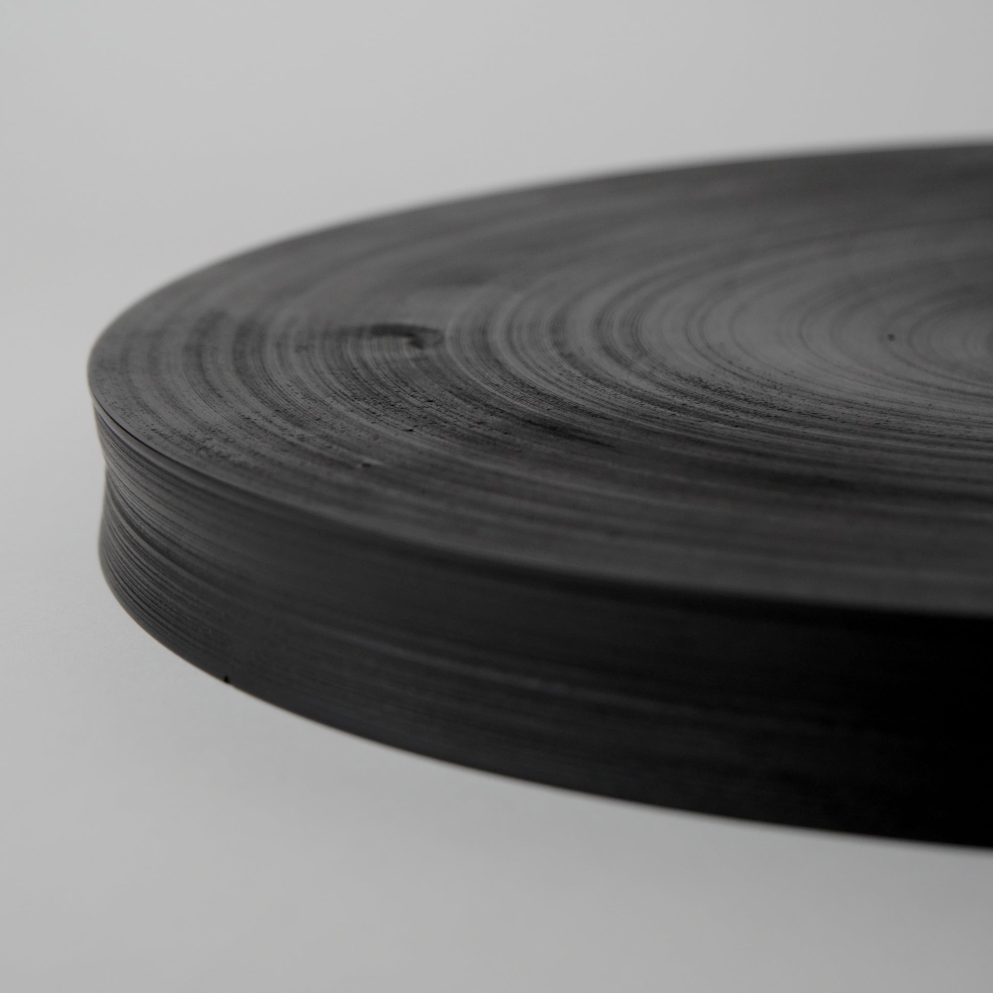 Roll of black tape on a light gray background