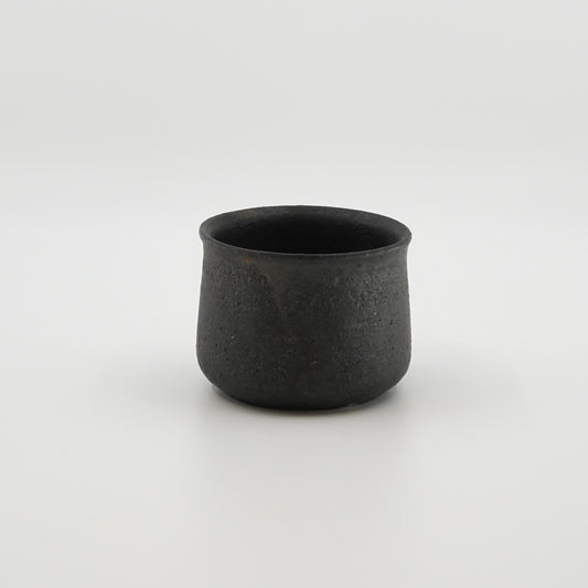 Black ceramic cup on a white background. Handmade ceramic cup by Japanese artist at Gallery tete Hong Kong.