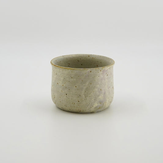 Speckled white ceramic cup on a white background. Handmade ceramic cup by Japanese artist at Gallery tete Hong Kong.