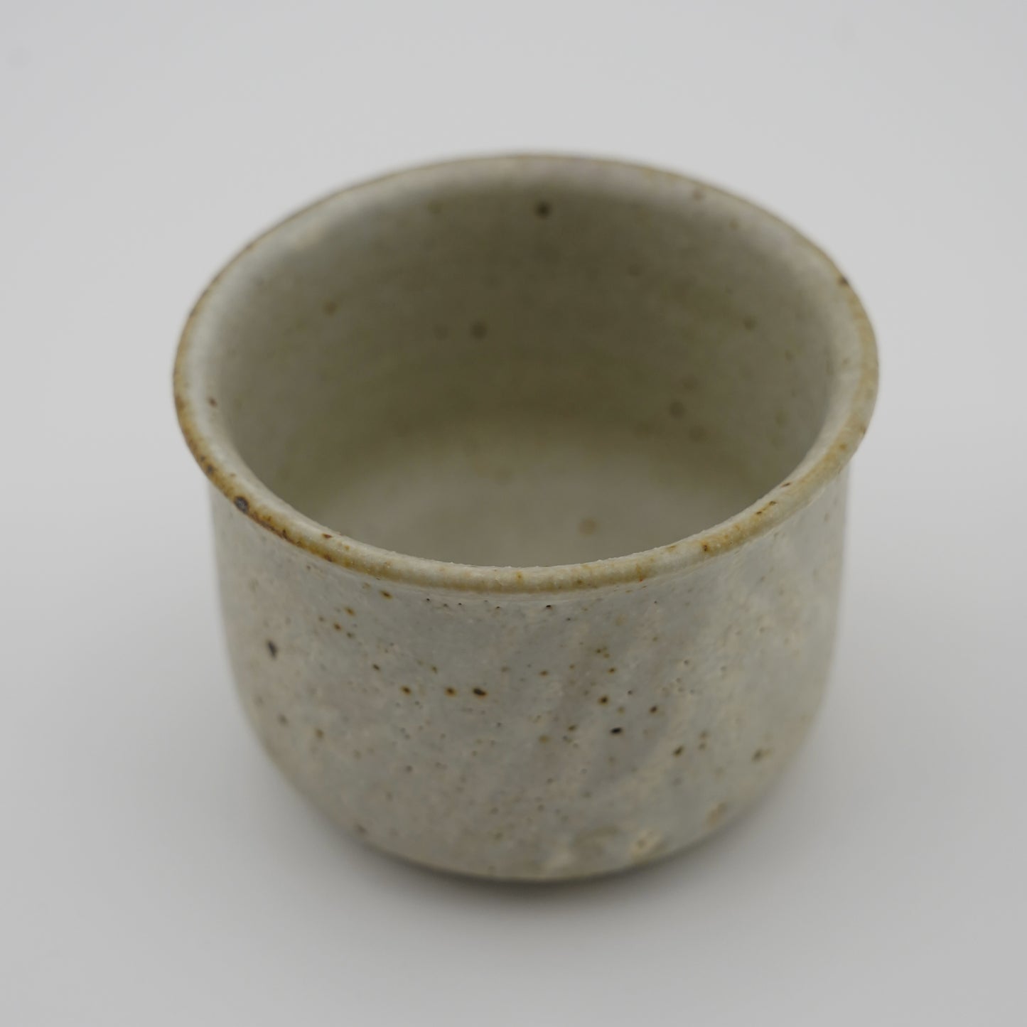 Ceramic cup with speckled texture on a white background. Handmade ceramic cup by Japanese artist at Gallery tete Hong Kong.