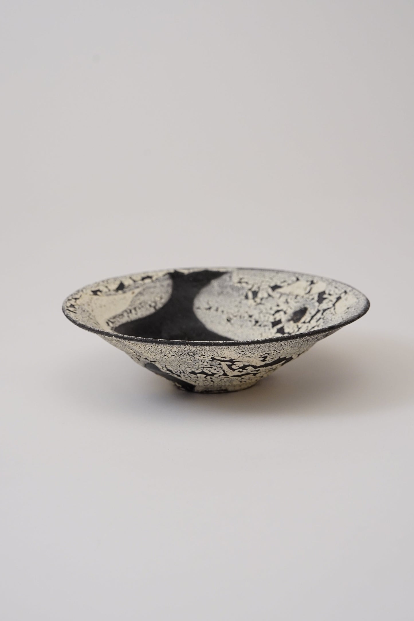 Ceramic bowl with a textured surface on a light gray background