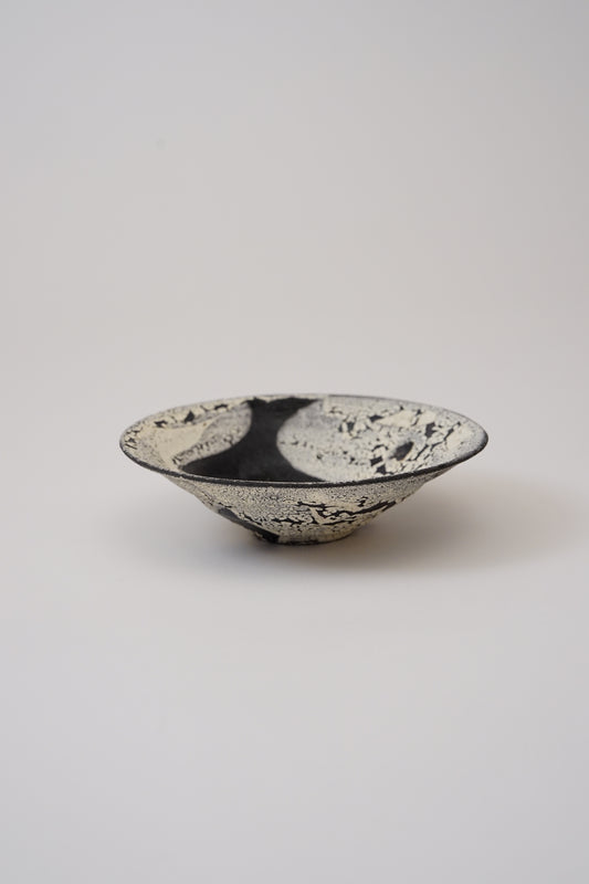 Ceramic bowl with a textured surface on a light gray background