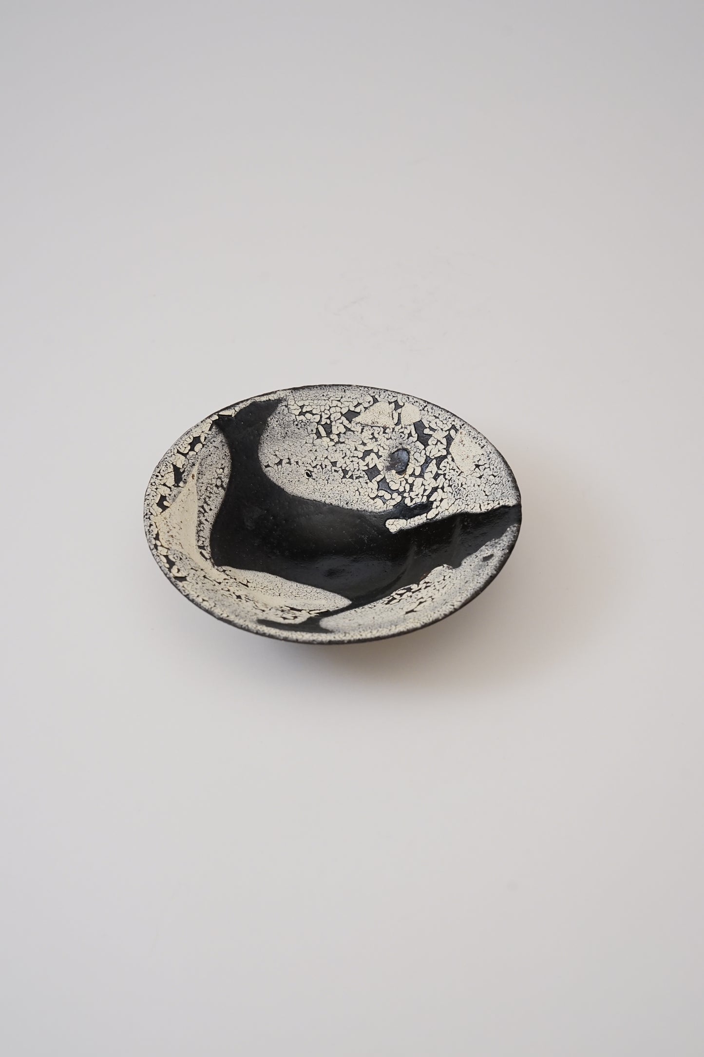 Black and white ceramic bowl on a light gray background