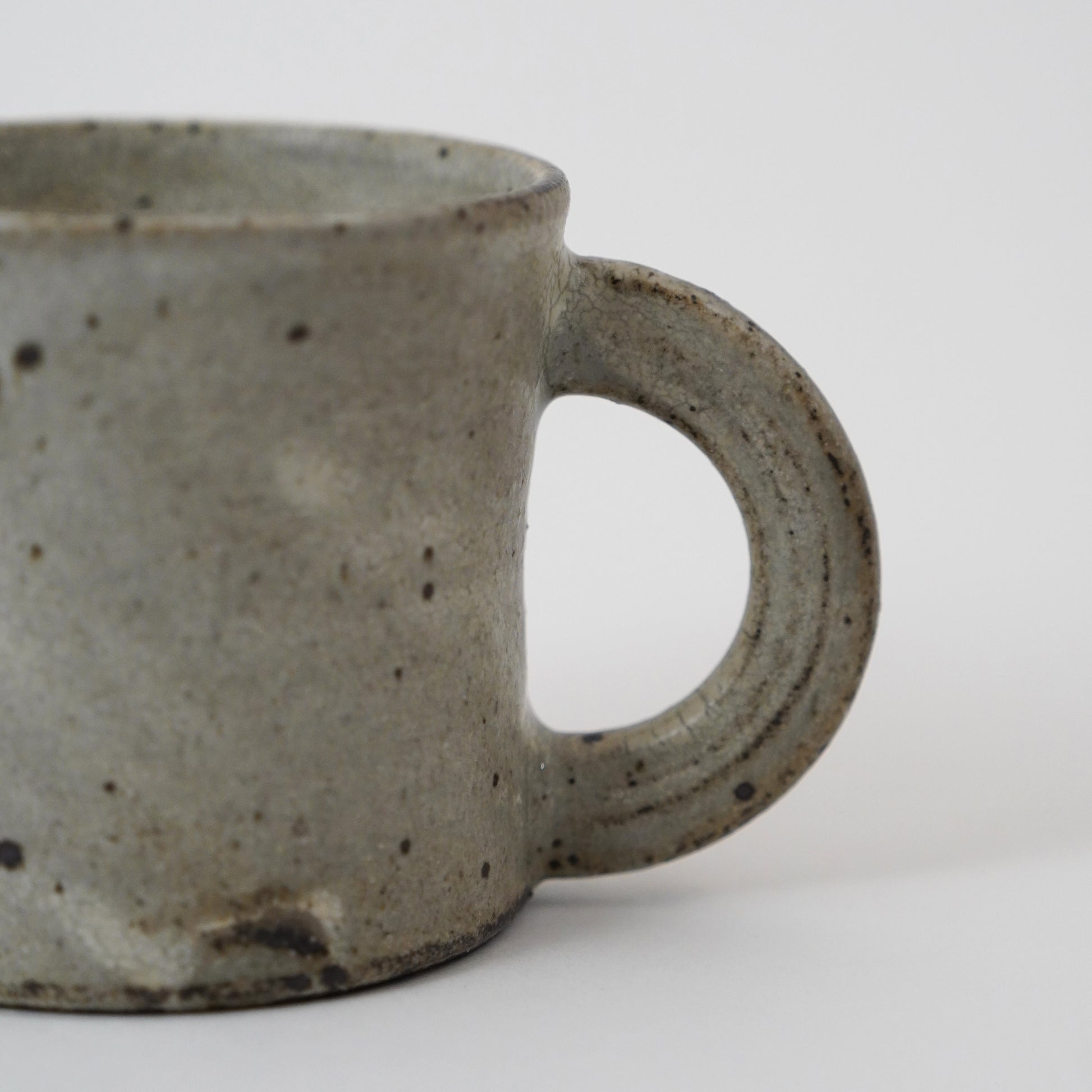 Speckled gray ceramic mug on a white background