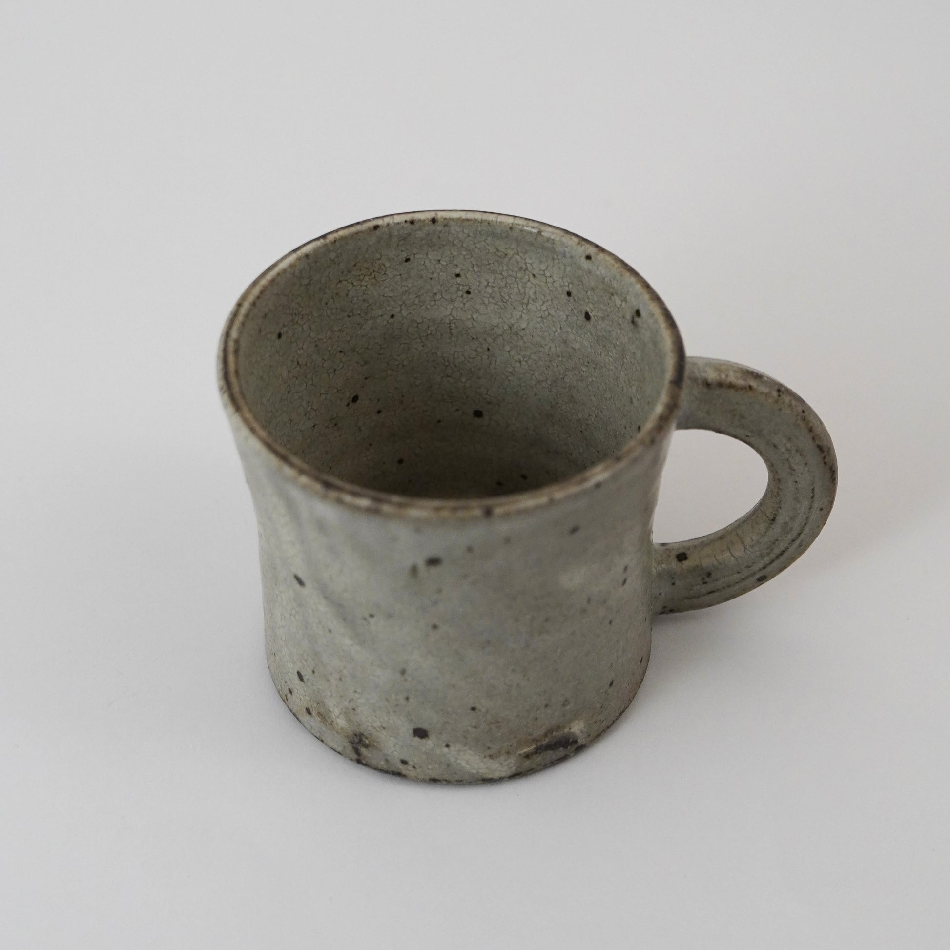 Ceramic mug with a handle on a white background