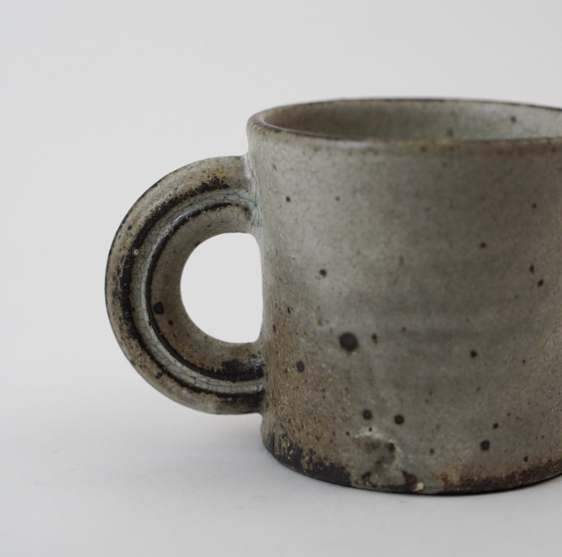 Stoneware mug with speckled texture on a white background