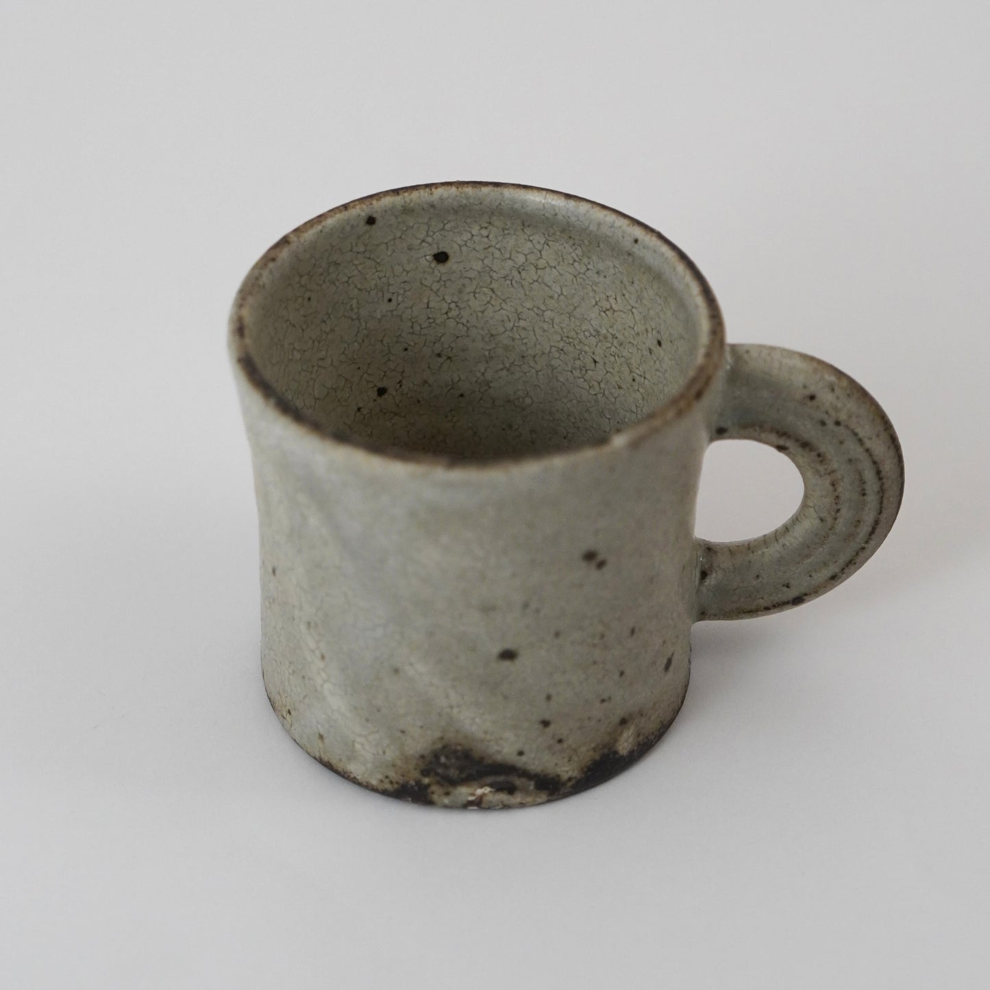 Ceramic mug with a handle on a white background