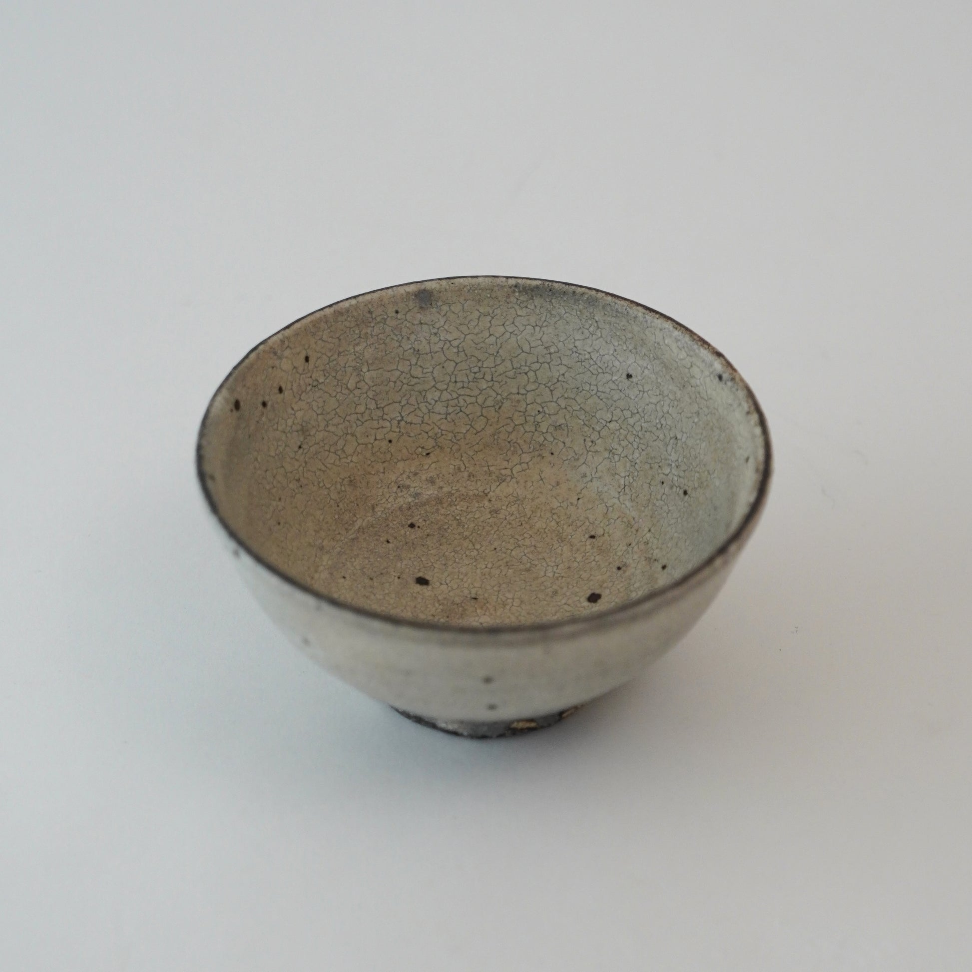 Ceramic bowl with speckled texture on a white background