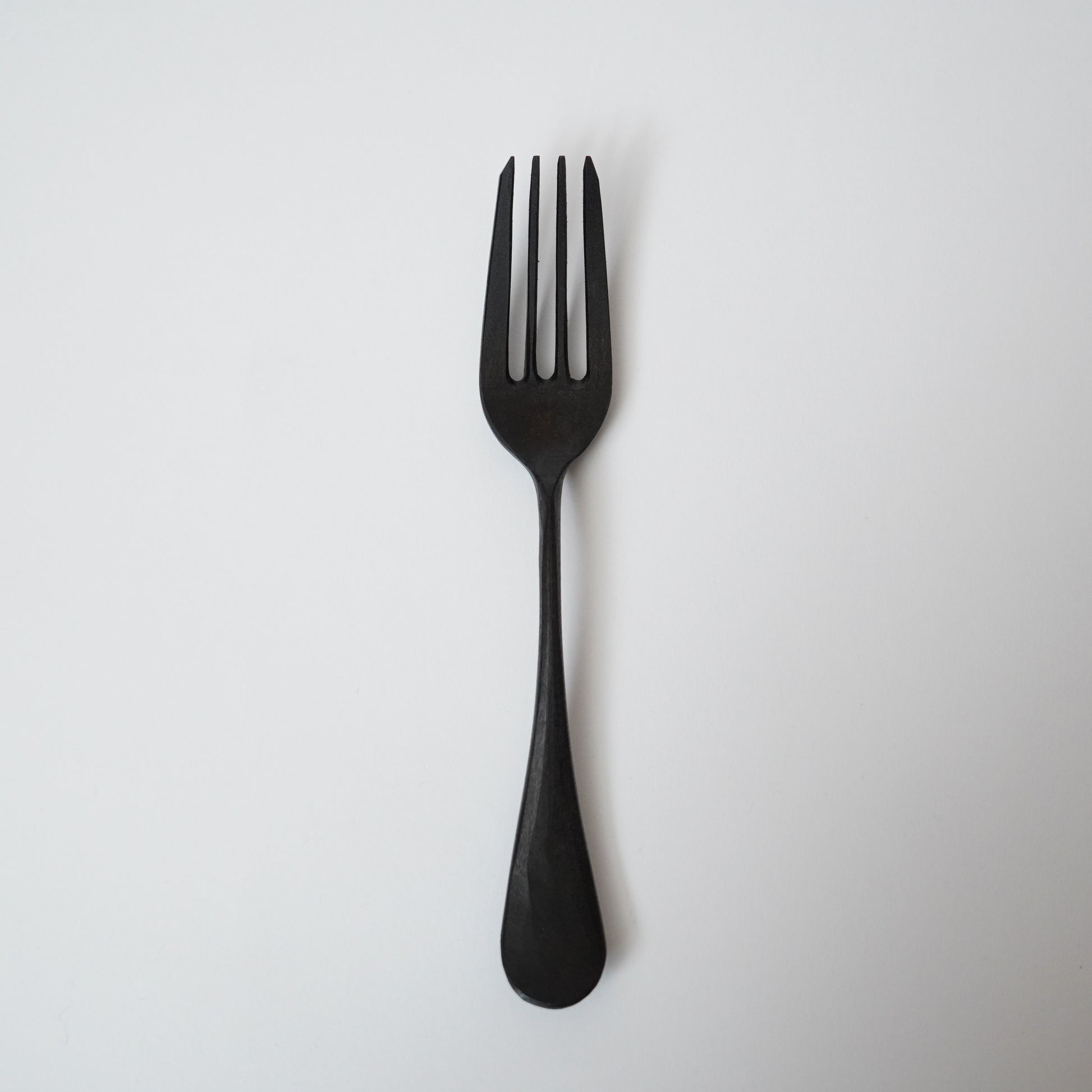 Black fork on a light gray background