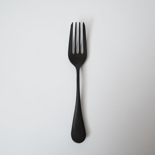 Black fork on a light gray background