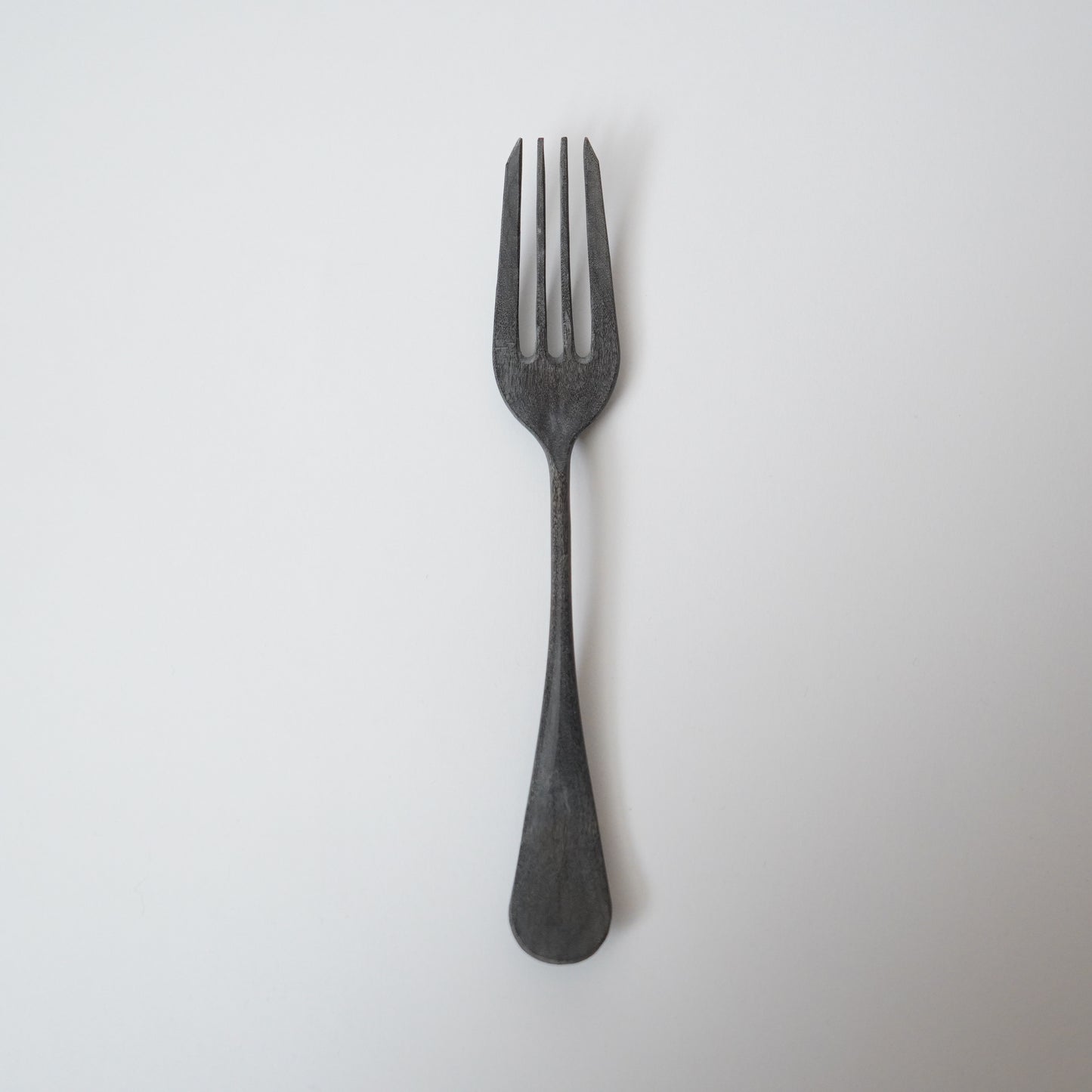 Black fork on a white background