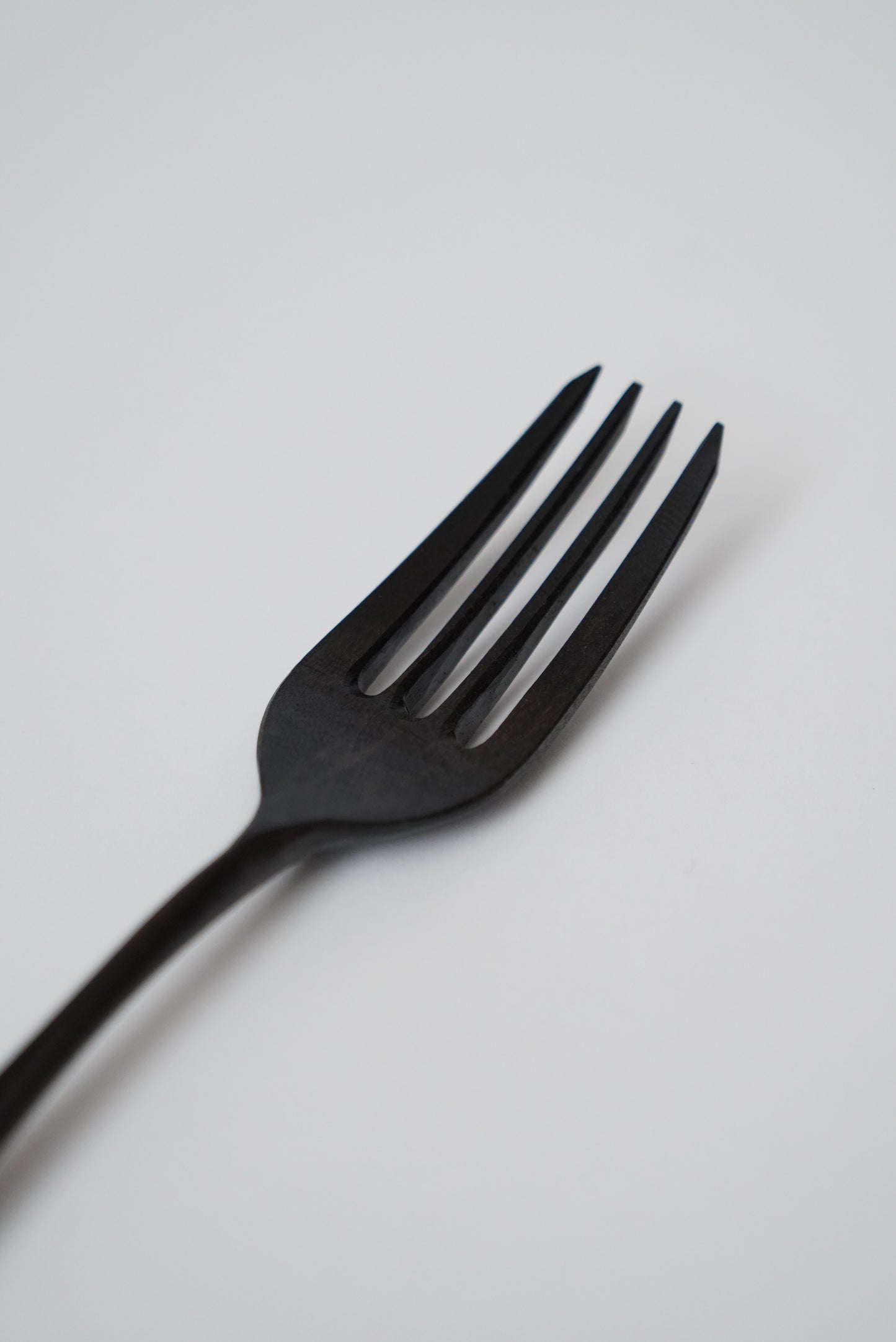 Black fork on a light gray background