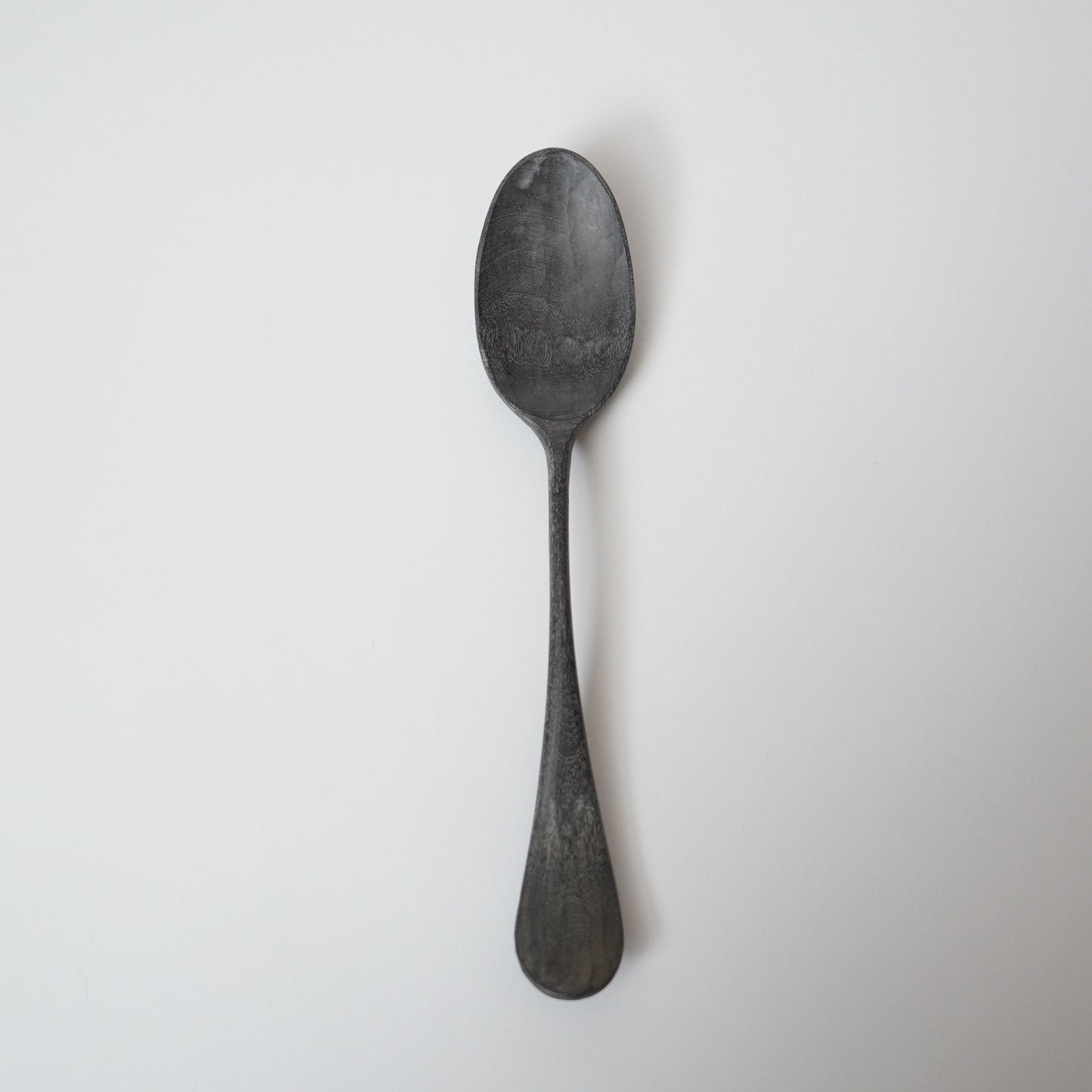 Black spoon on a white background