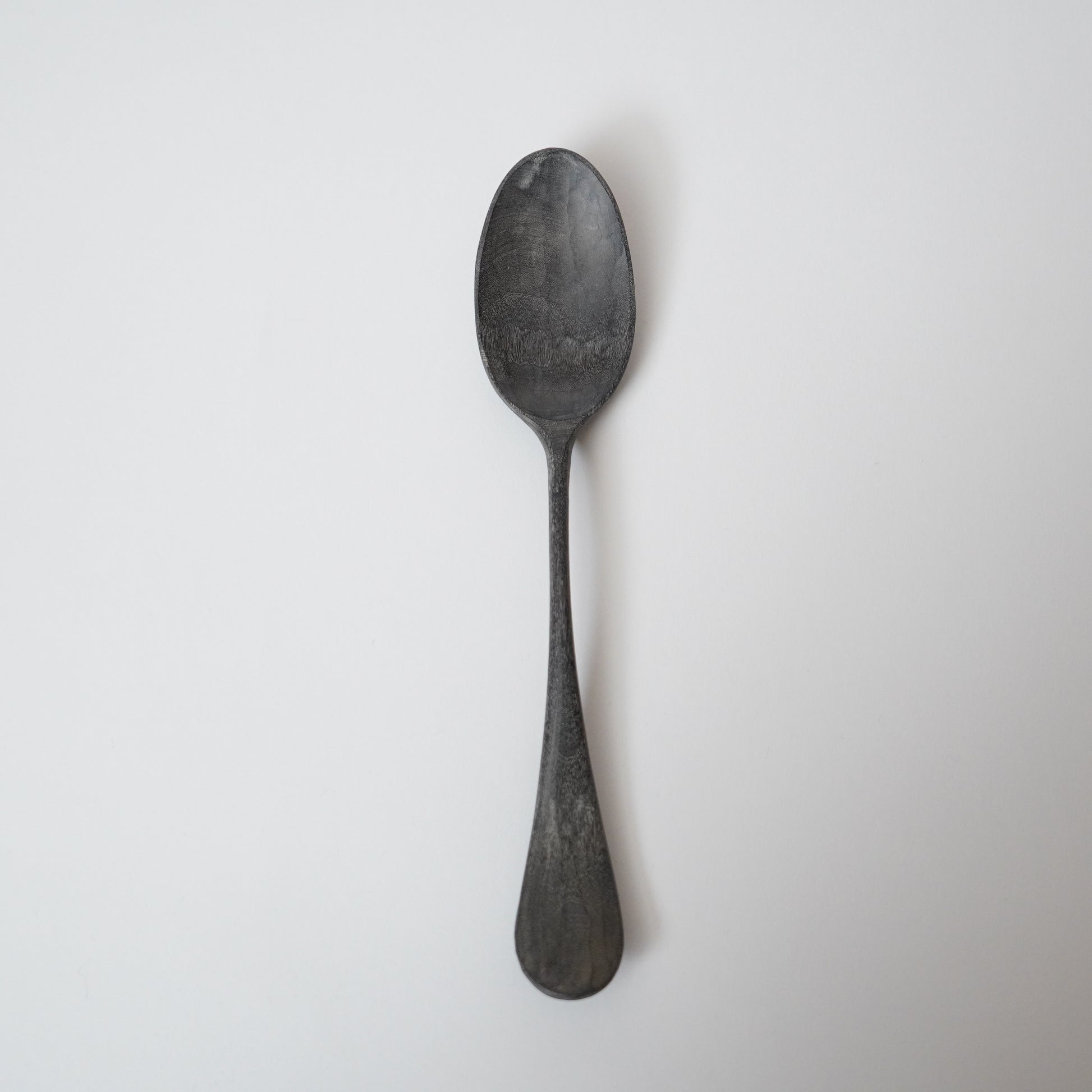 Black spoon on a white background