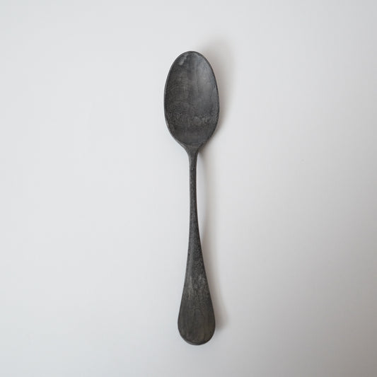 Black spoon on a white background