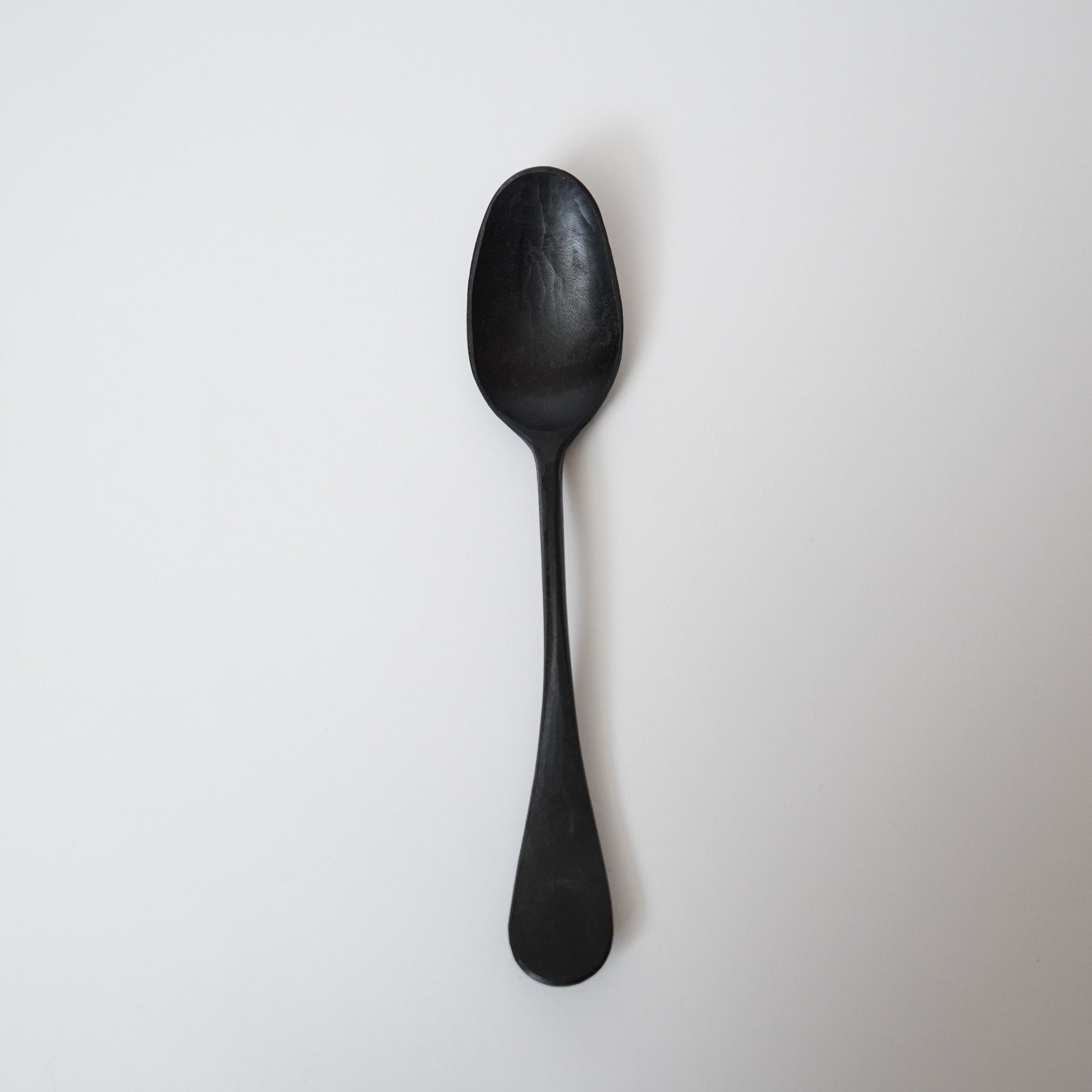 Black spoon on a white background