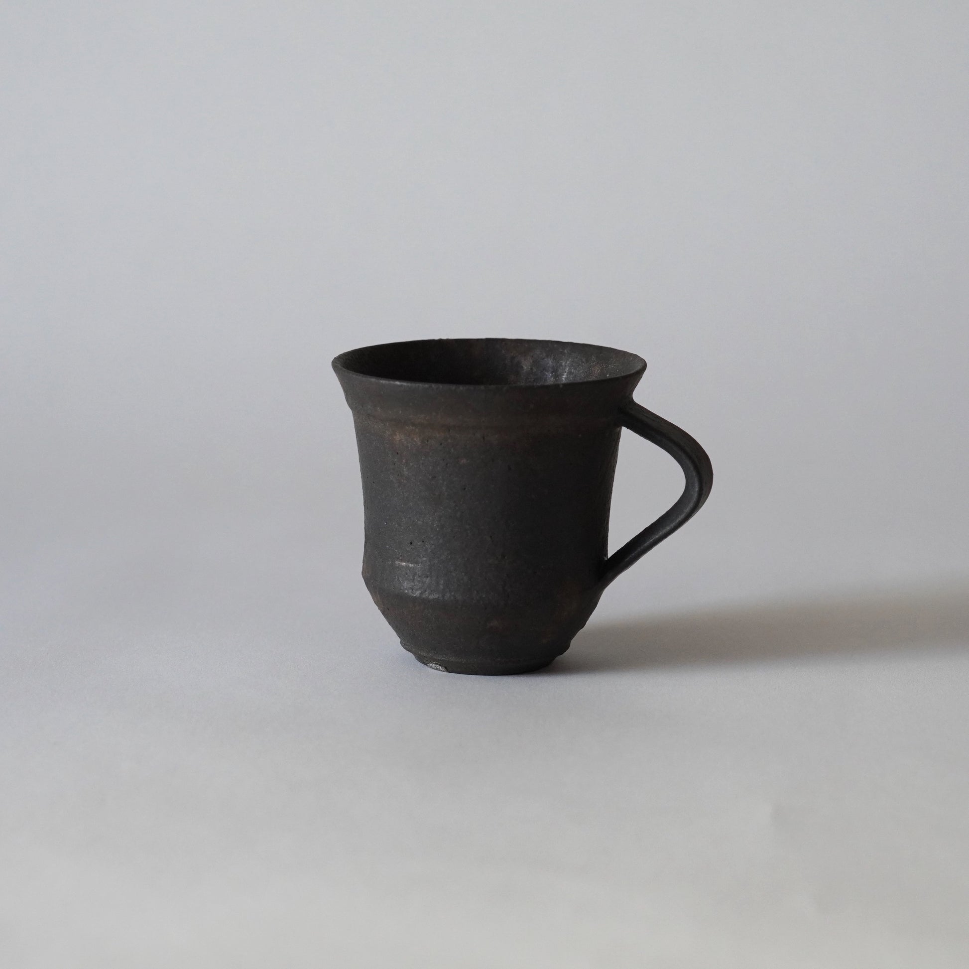 Black ceramic mug on a white background