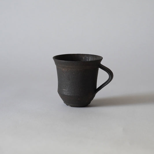 Black ceramic mug on a white background