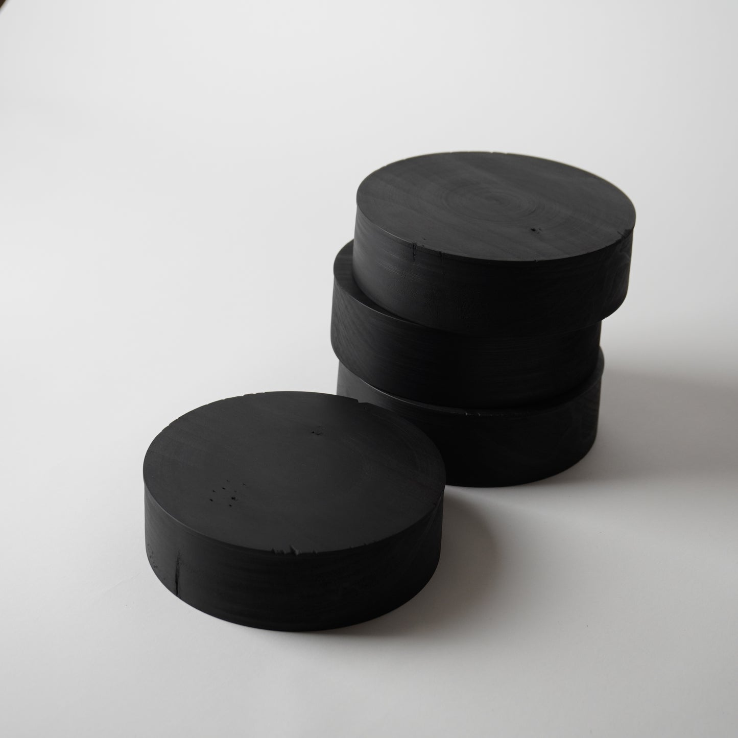 Stack of black cylindrical objects on a white background