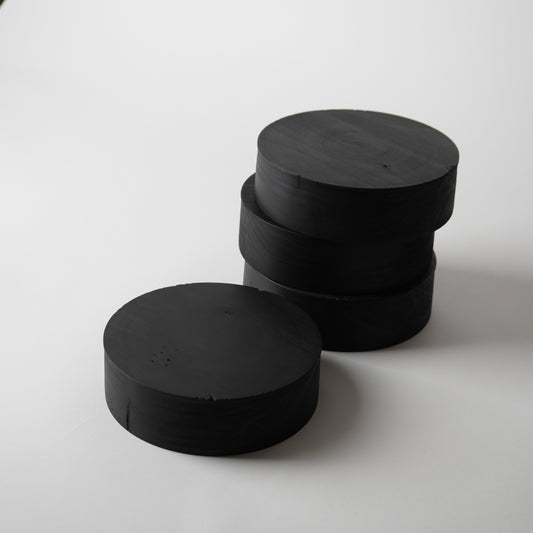 Stack of black cylindrical objects on a white background