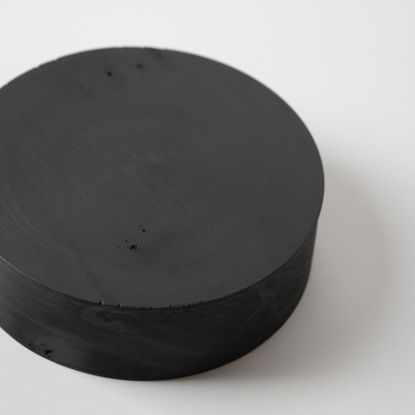 Stack of black circular objects on a white background