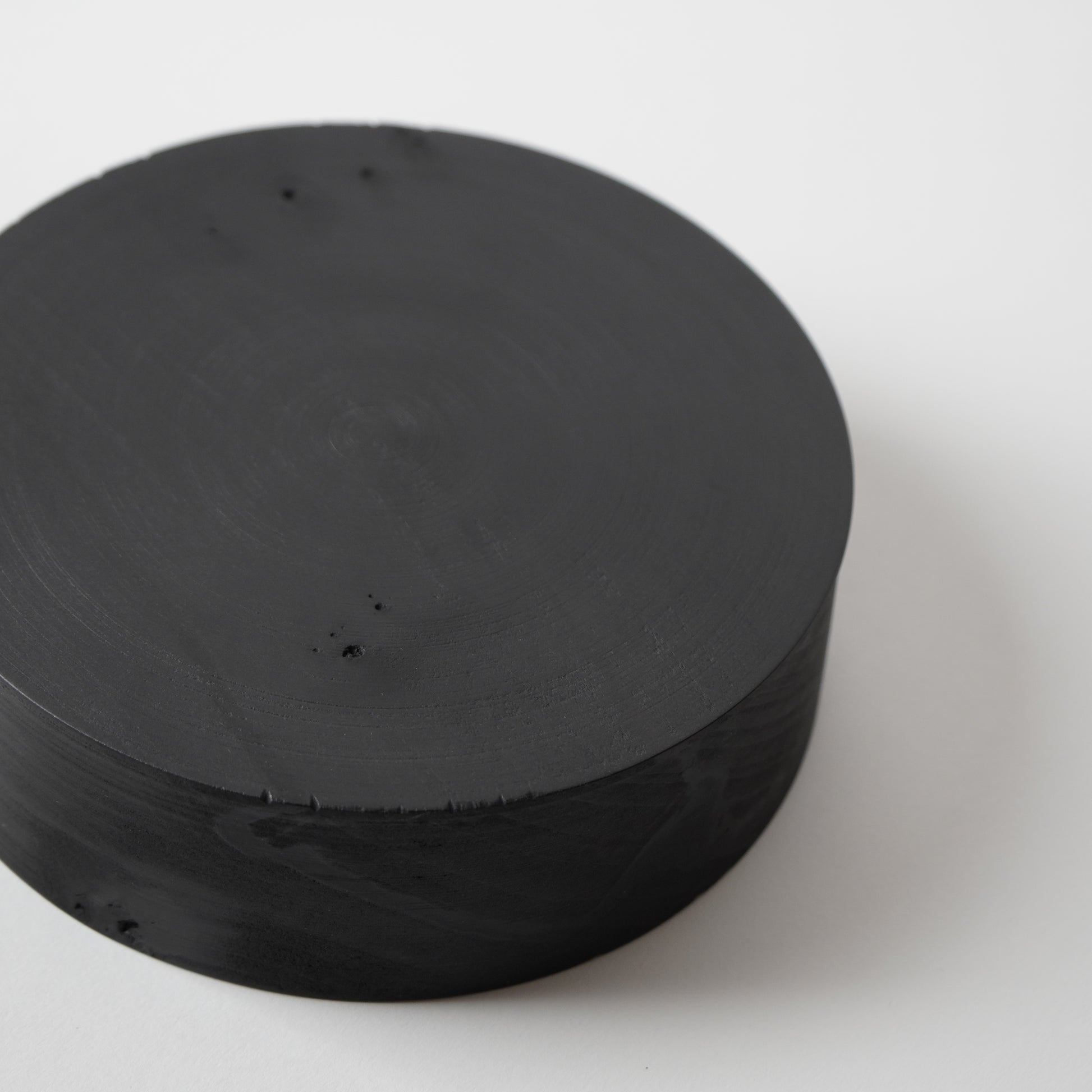 Stack of black circular objects on a white background