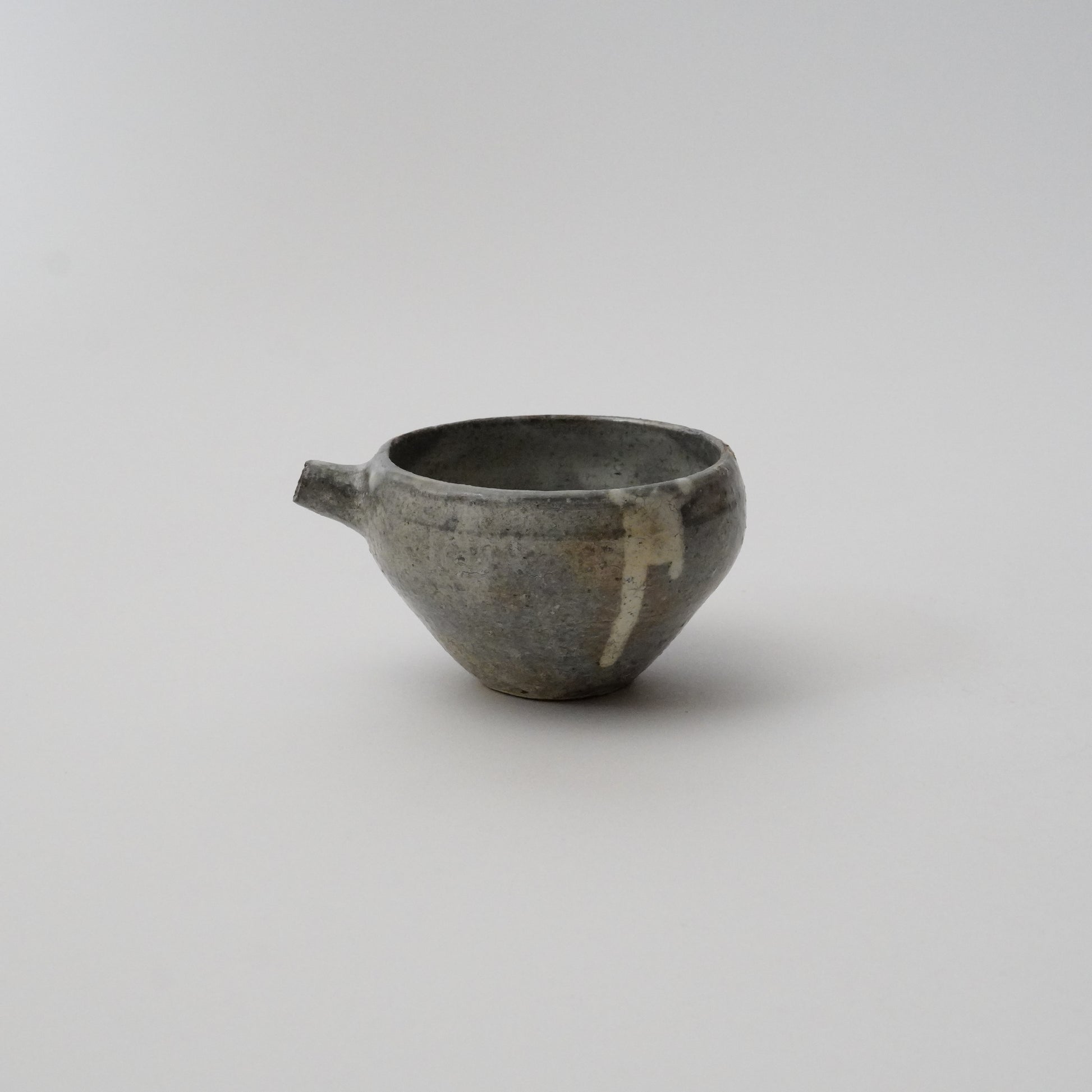 A black ceramic pitcher with a simple, rustic design, displayed against a white background.