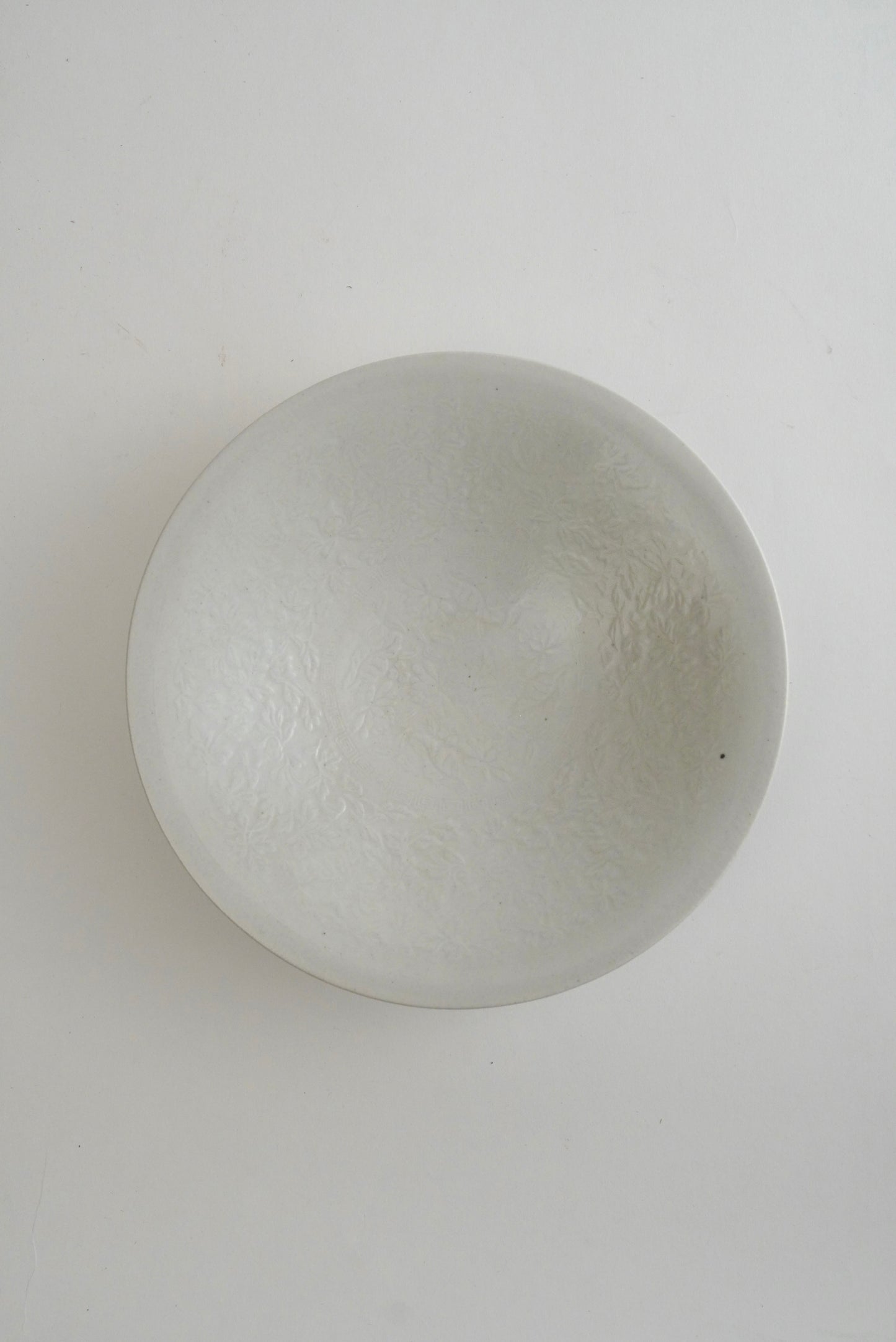 A round, dome-shaped frosted glass bowl with a textured, cloudy finish, photographed from directly above on a plain white background.