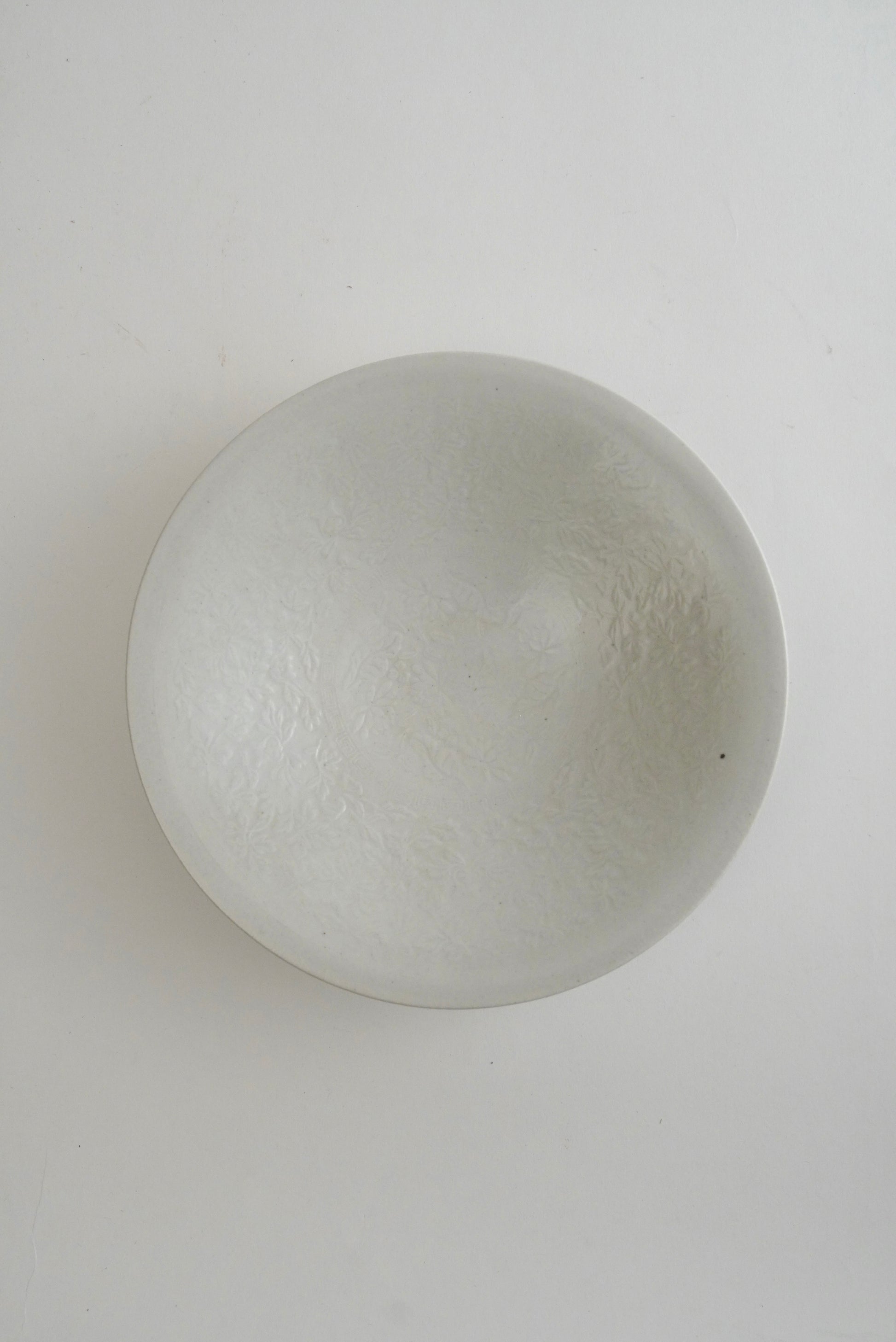 A round, dome-shaped frosted glass bowl with a textured, cloudy finish, photographed from directly above on a plain white background.