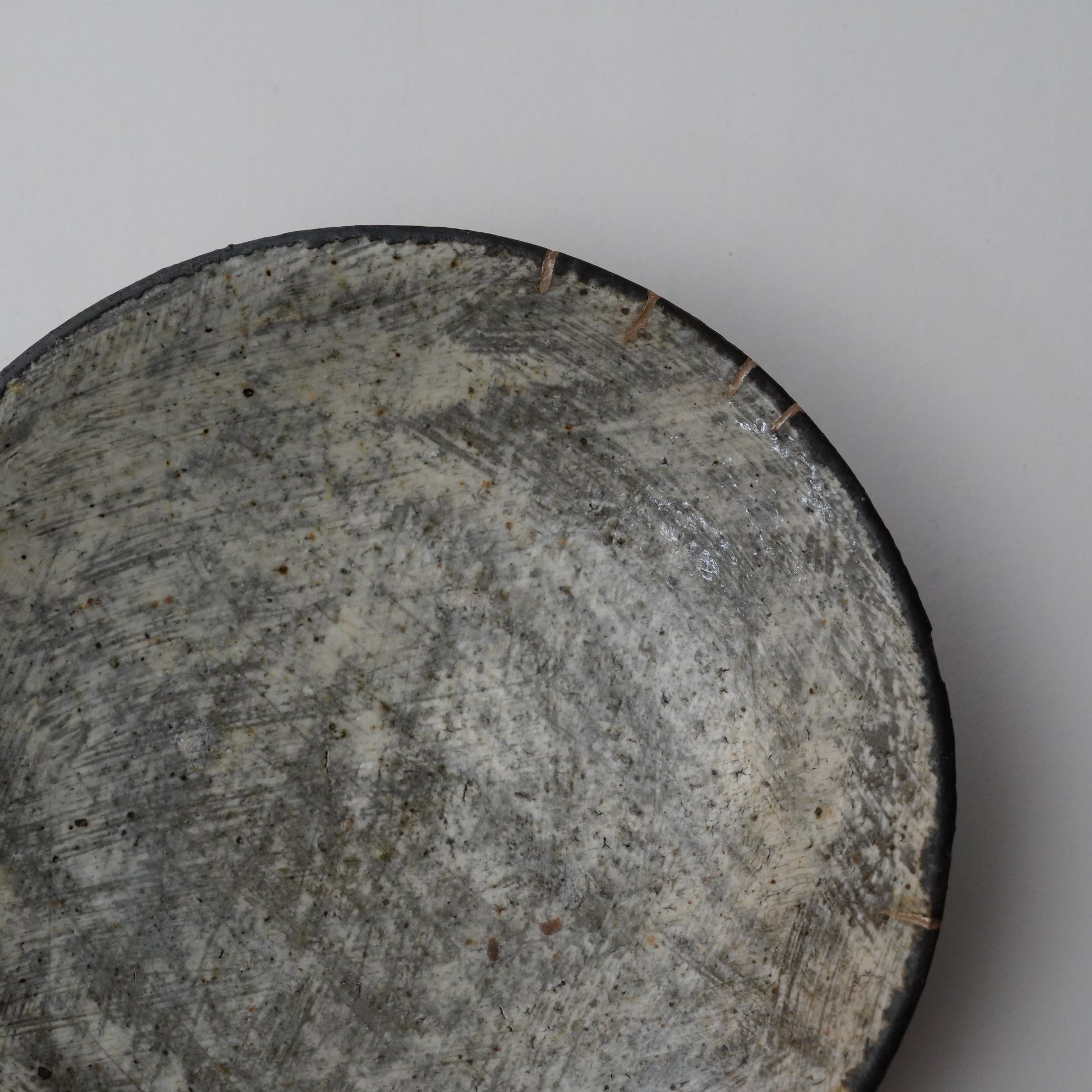 Close-up of a textured stone surface on a plain background