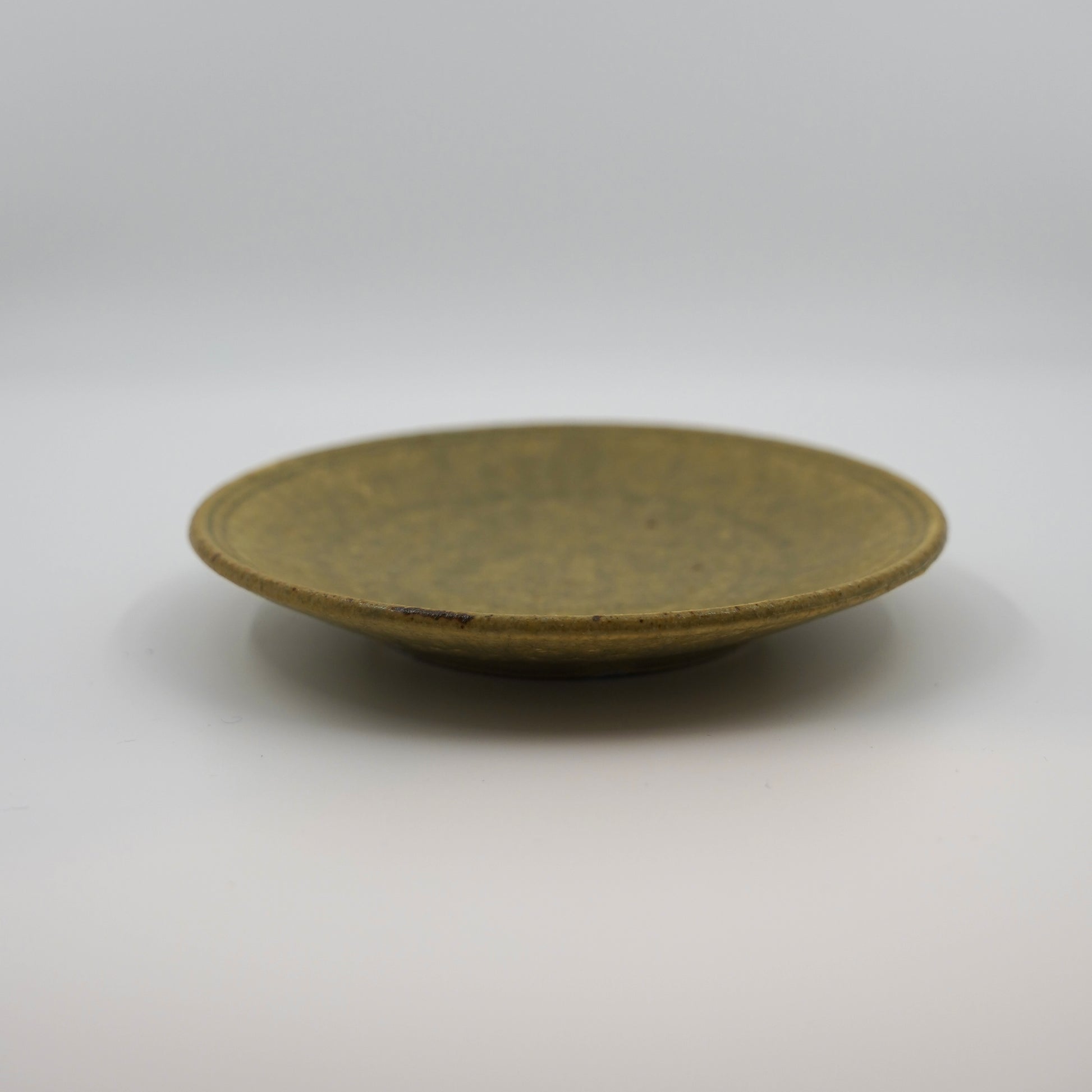 Ash color ceramic plate on a white background