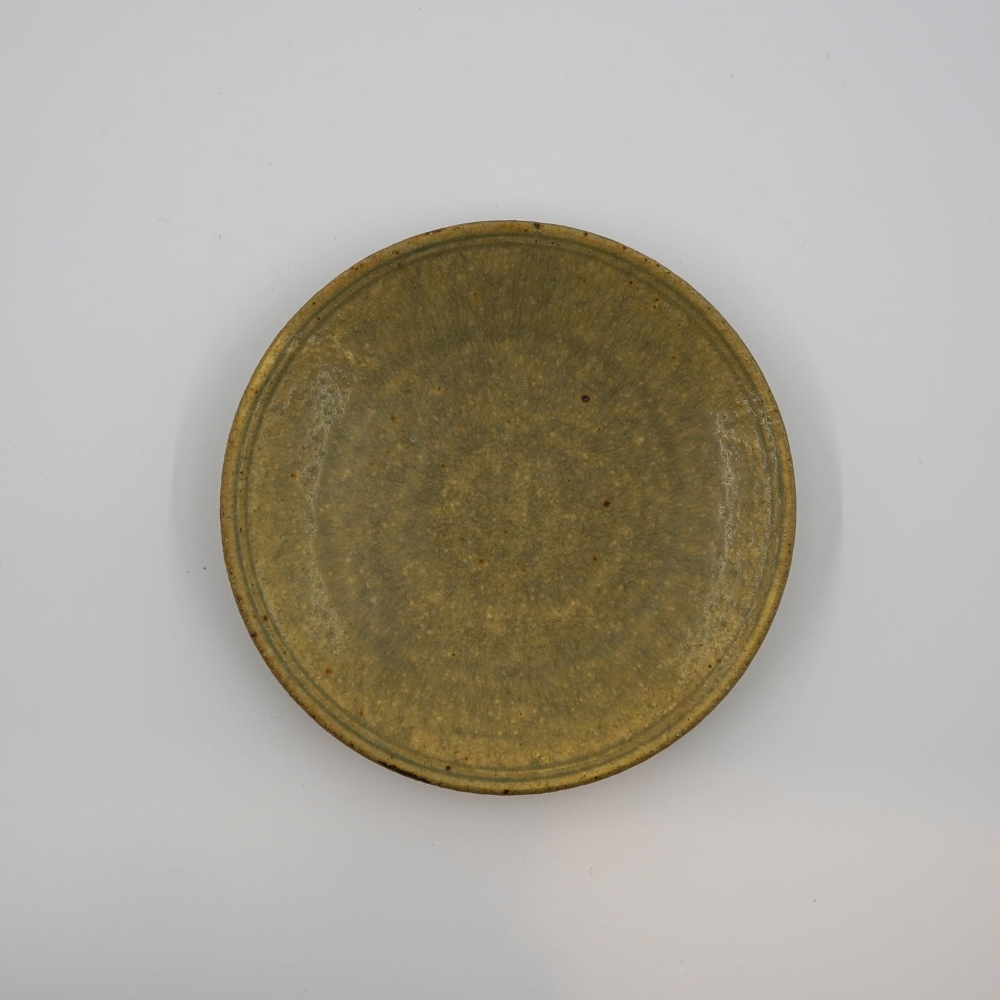 Round metallic object on a gray background